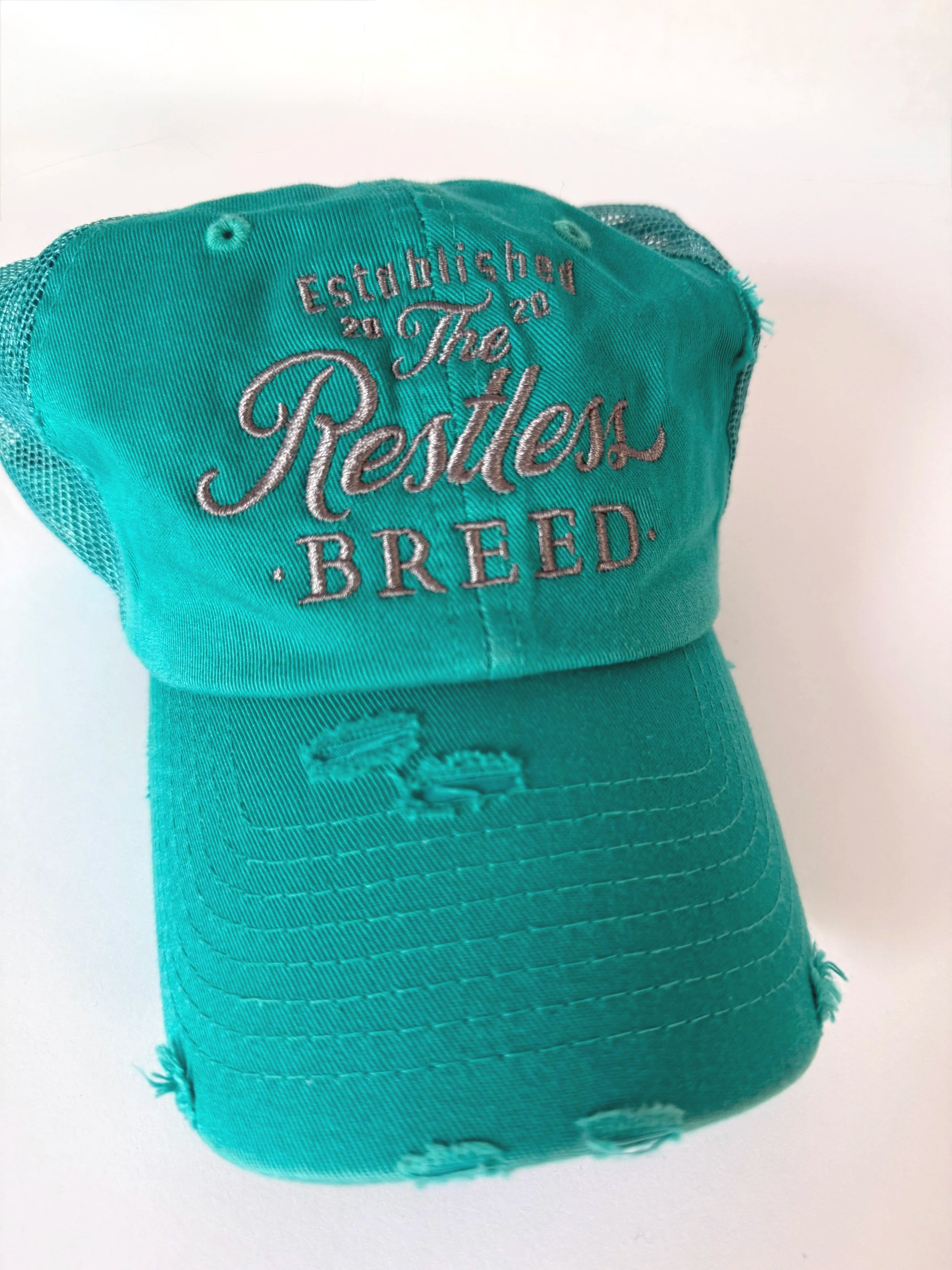 turquoise baseball hat