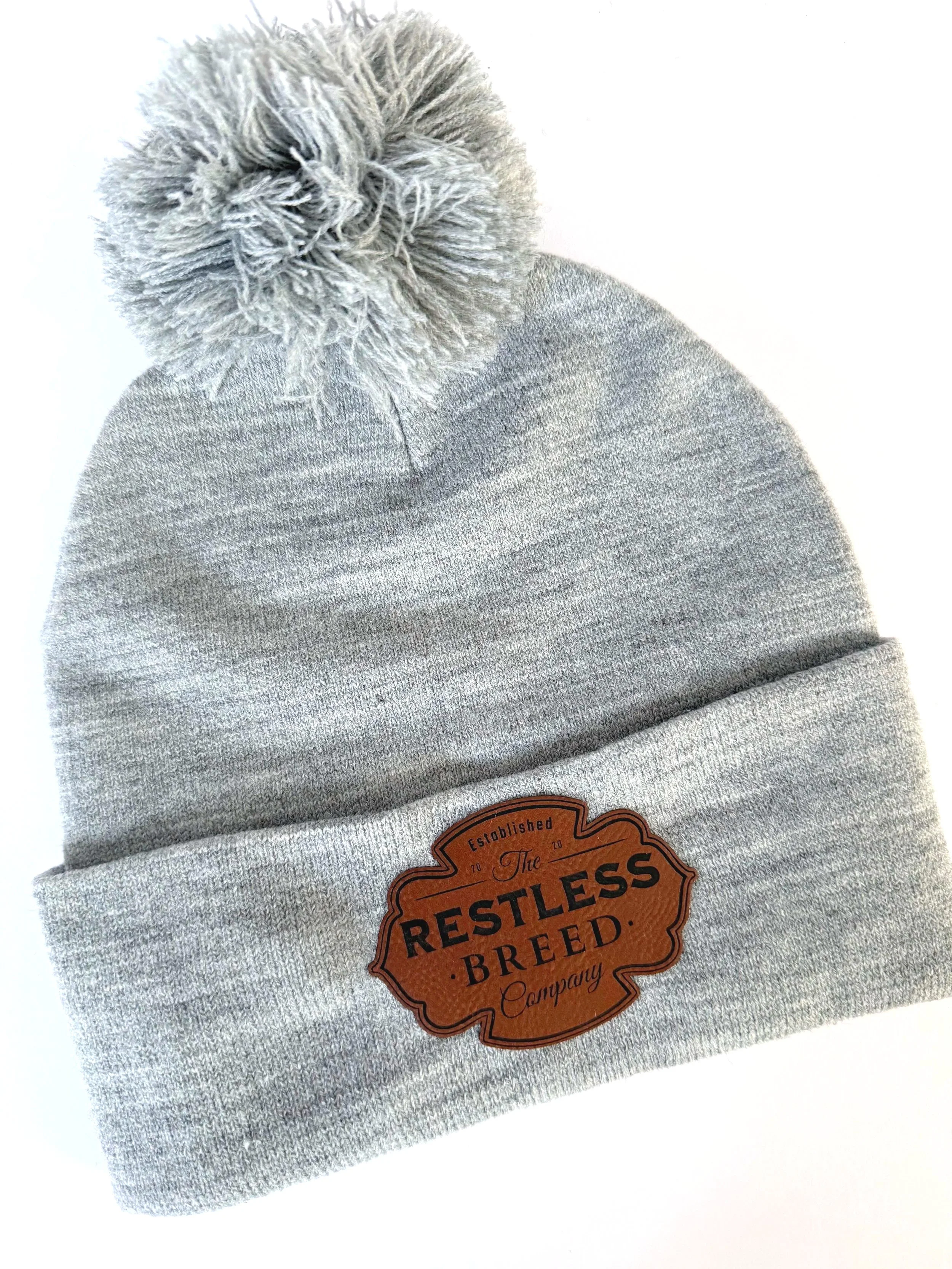 grey ski hat with pom pom