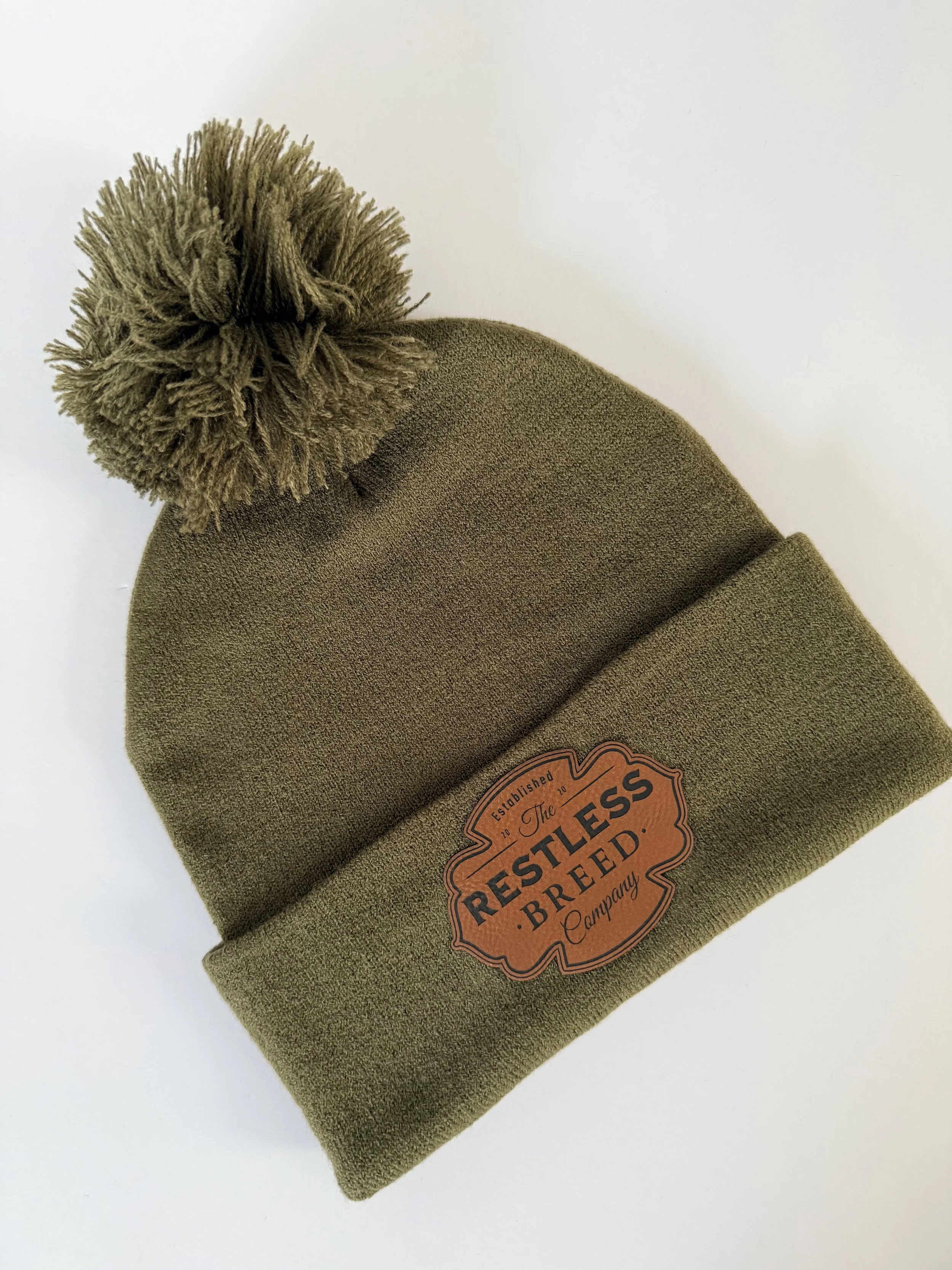 green ski hat with pom pom