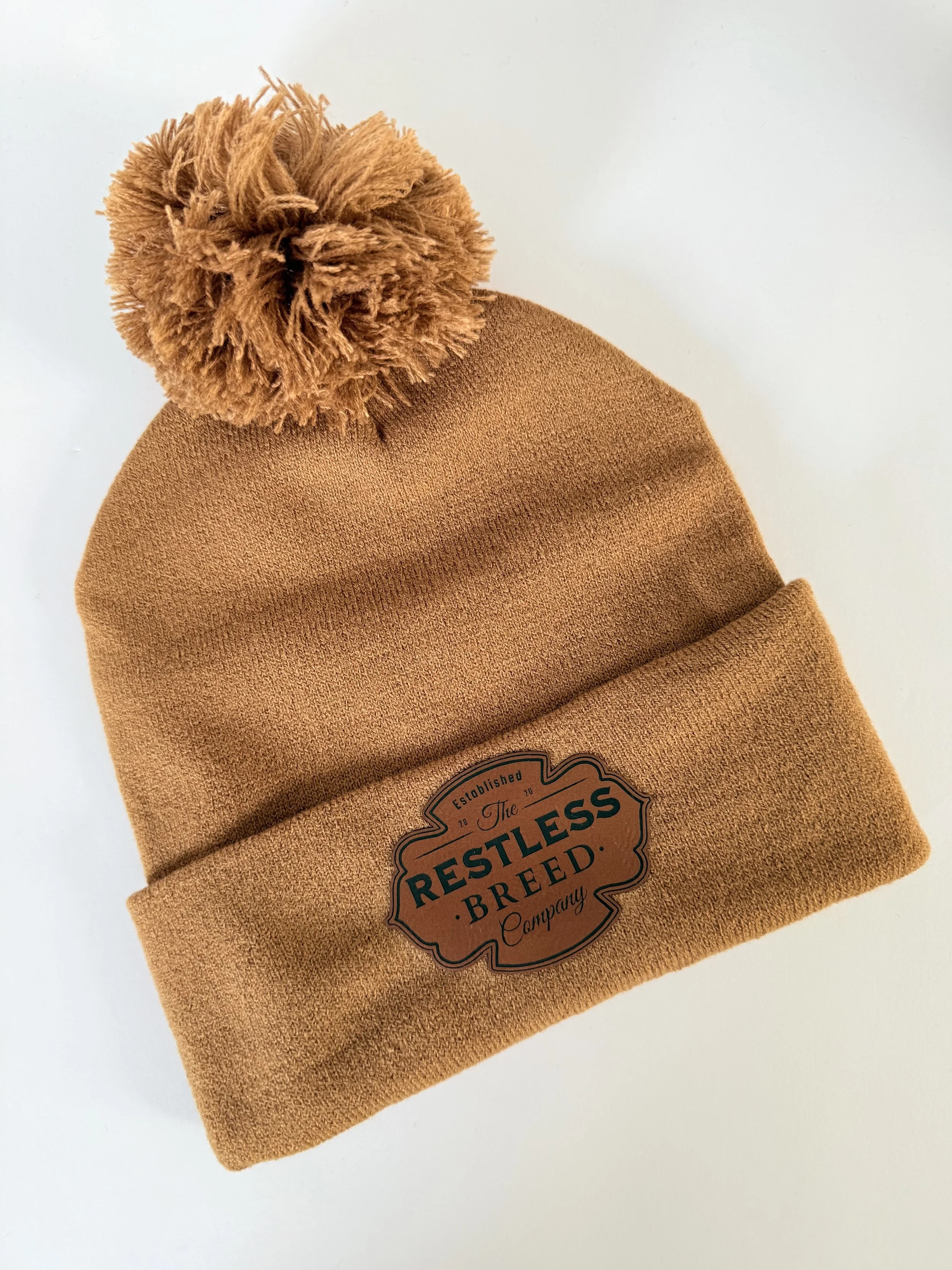 Camel colored ski hat with pom pom