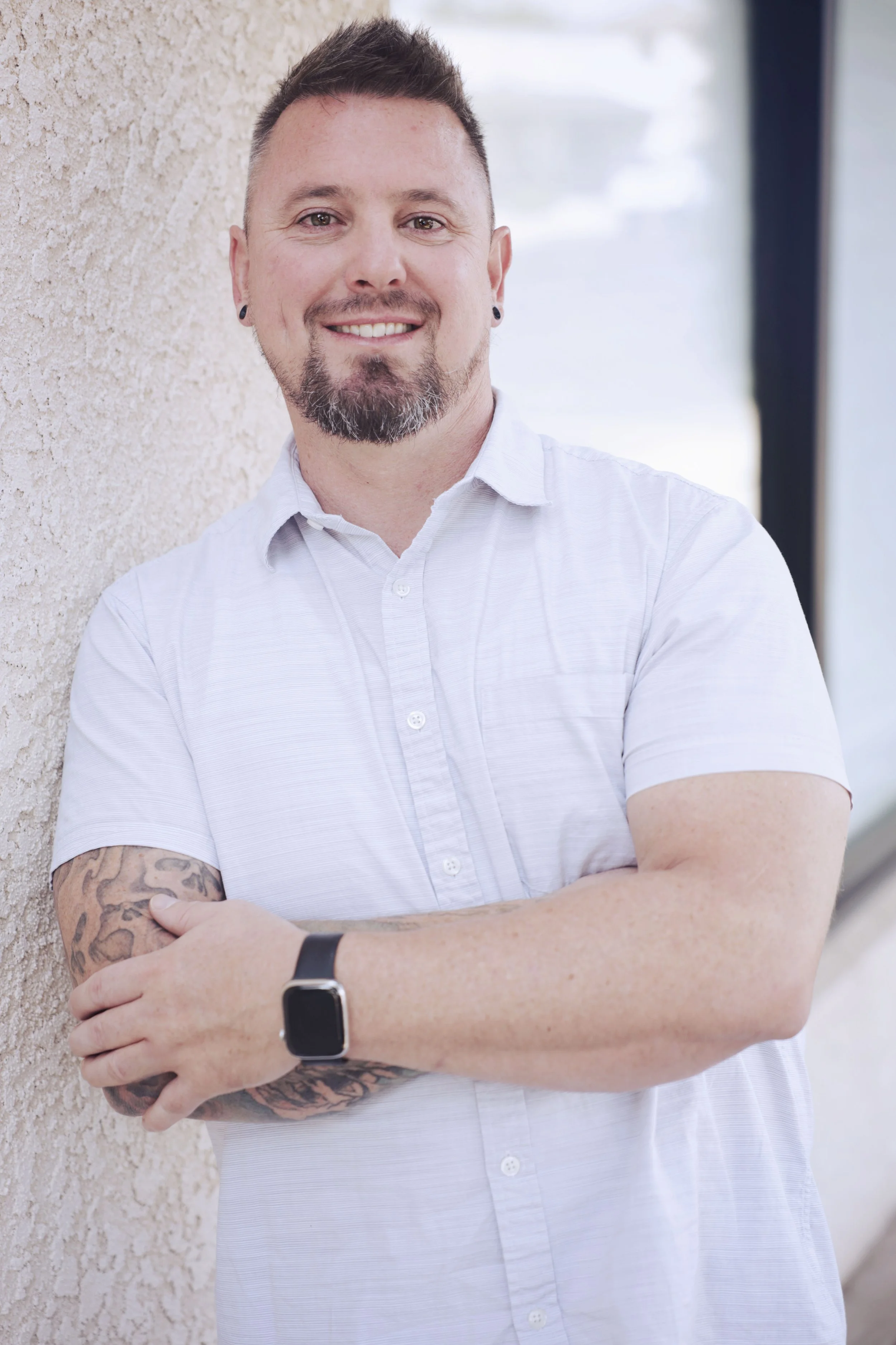 an image of Nathan Tomshack smiling at the camera