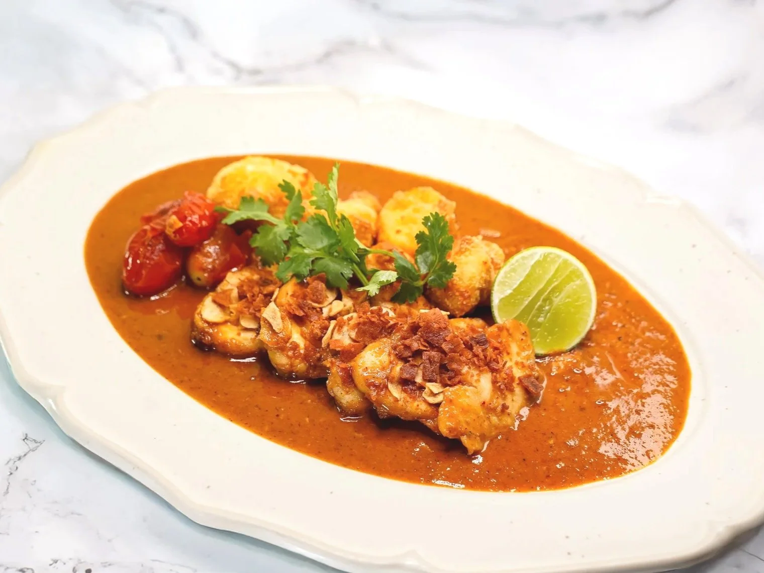 Monk Fish in a spicy Tom Yum sauce, paired with cripy fried Cauliflower and bacon
