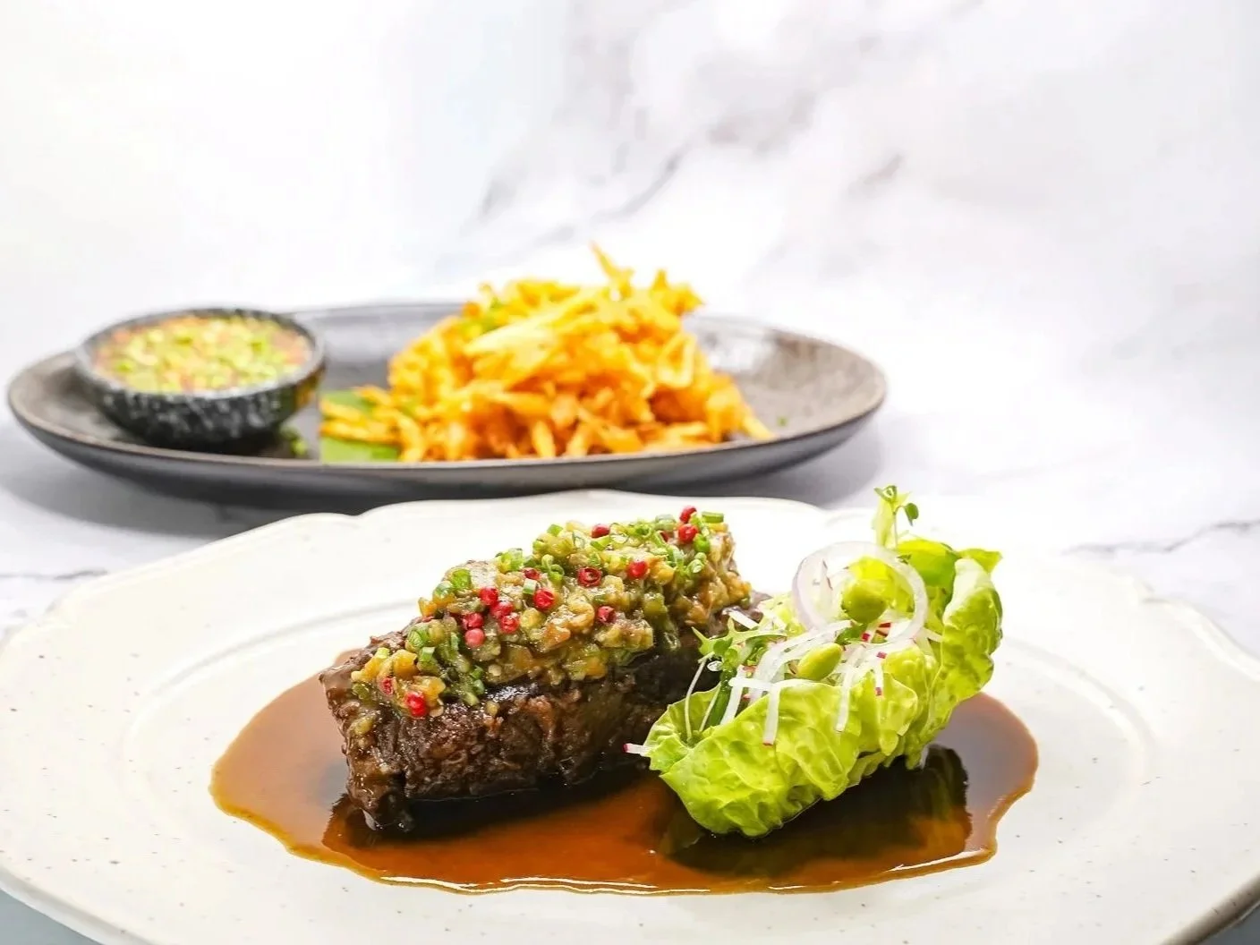 Sous Vide Beef Short Rib on top Thai Eggplant Chimichurri Sauce Served with Crispy Papaya Salad