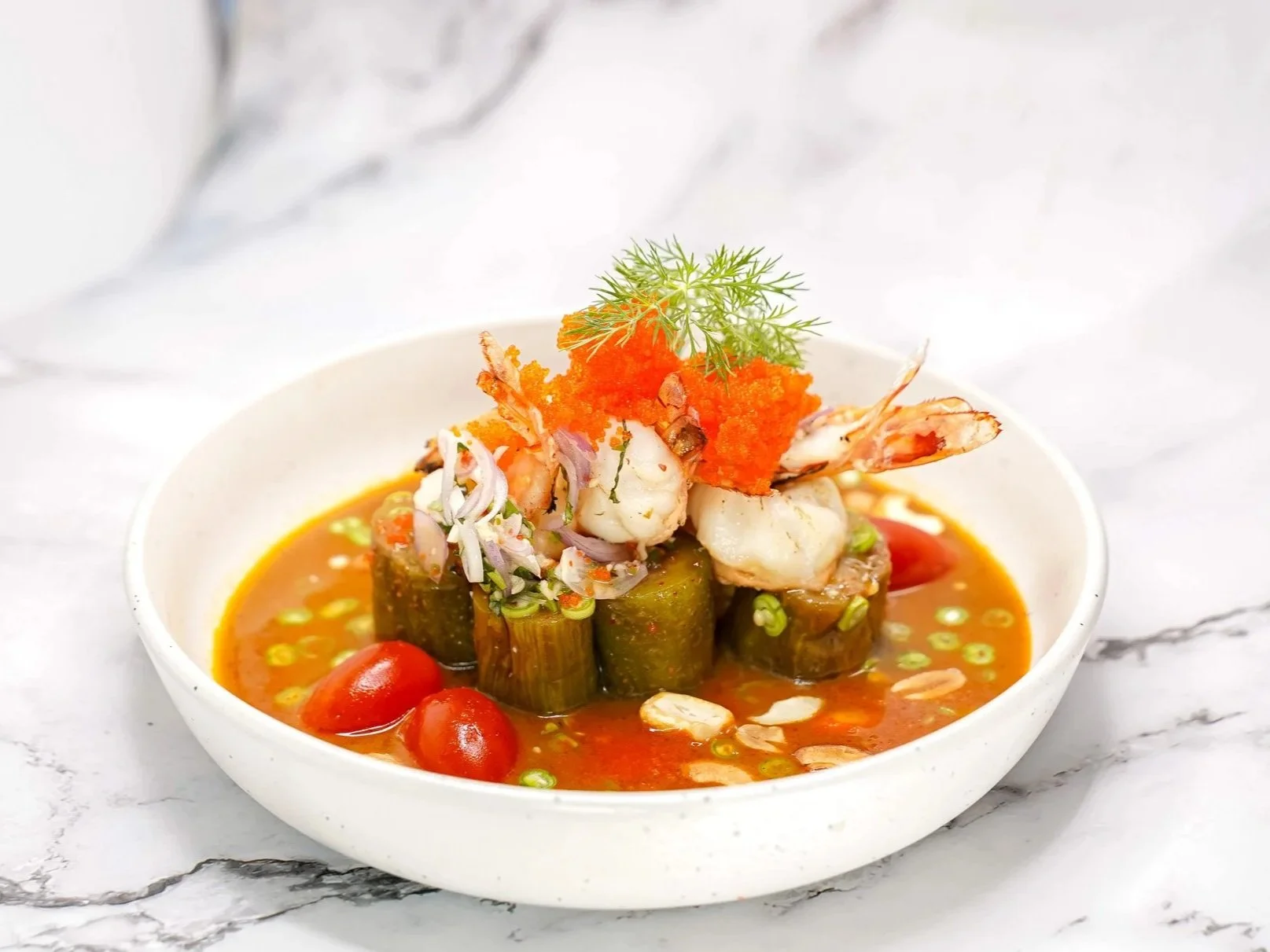 BBQ Thai long eggplant salad with grilled tiger prawns, roasted chili dressing, and cashew nuts.