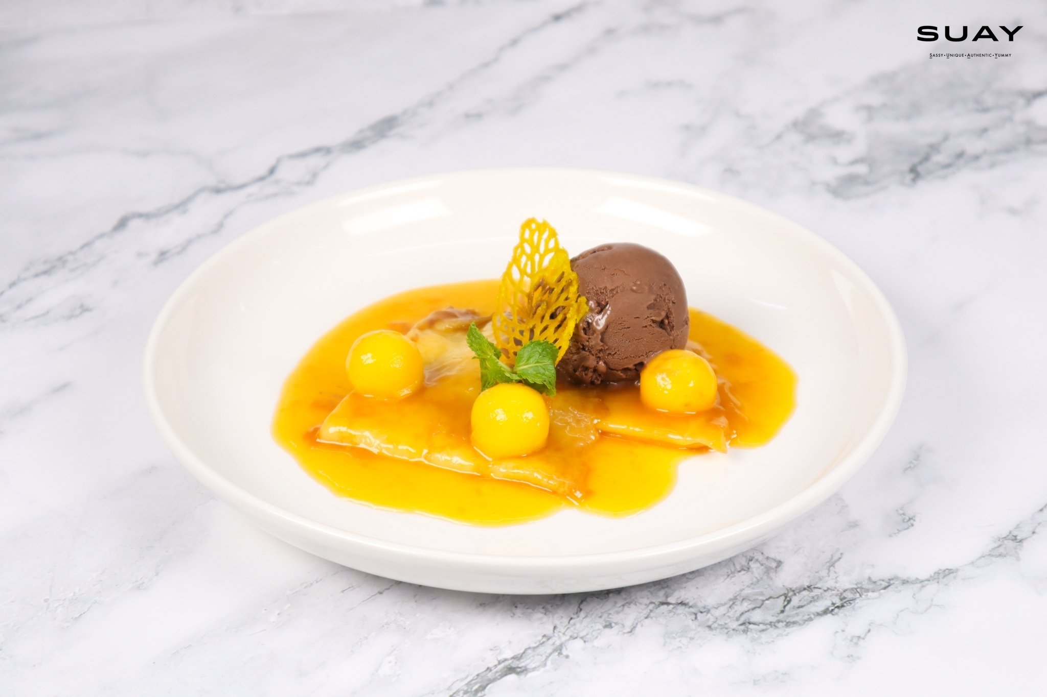 Mango crepes suzette side table service with chocolate ice cream and Fresh Thai mango balls
