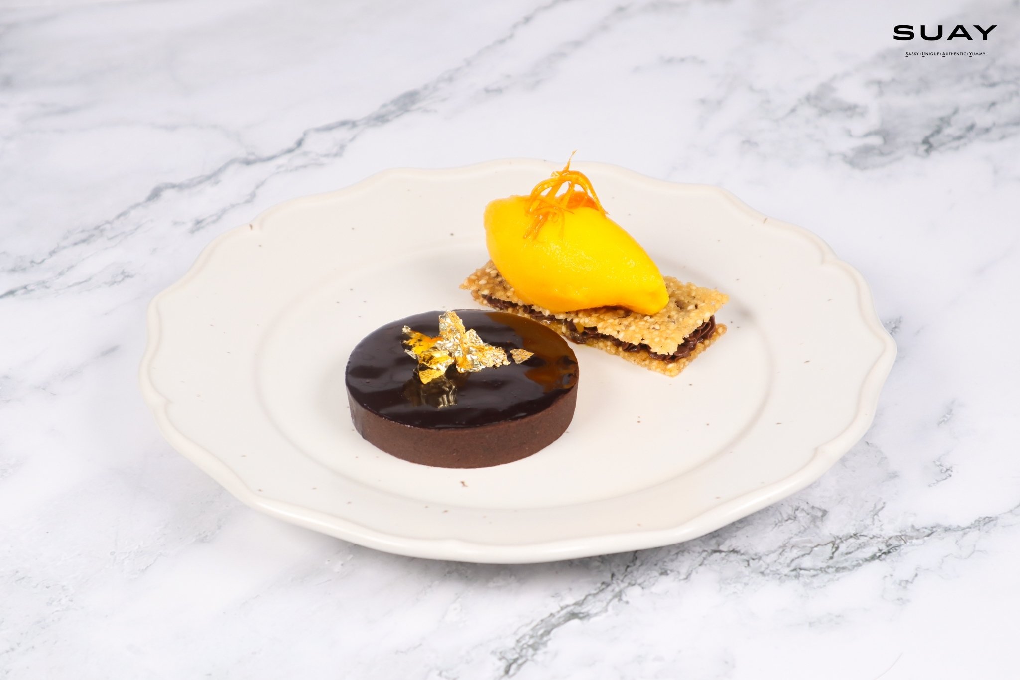 Homemade Thai chocolate tart with mandarin yuzu sorbet, caramel sesame Tuile