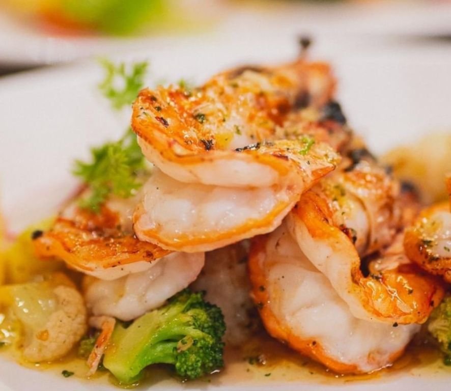 Char-grilled King prawns with choices of garlic butter or tom yum sauce served with grilled vegetables