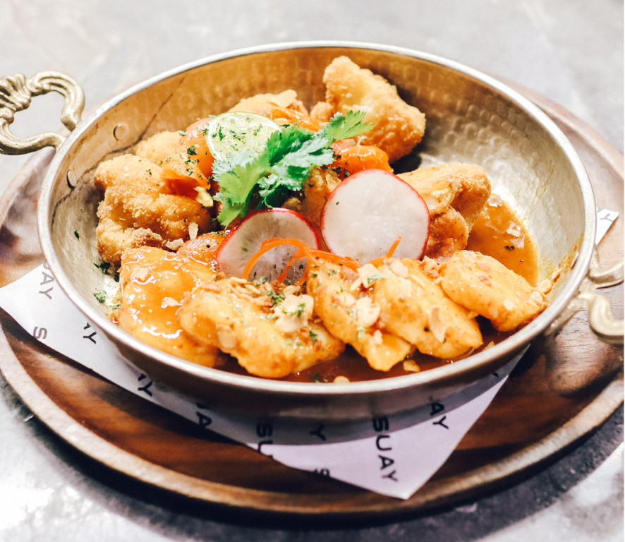 Monk Fish in a spicy Tom Yum sauce, paired with cripy fried Cauliflower and bacon