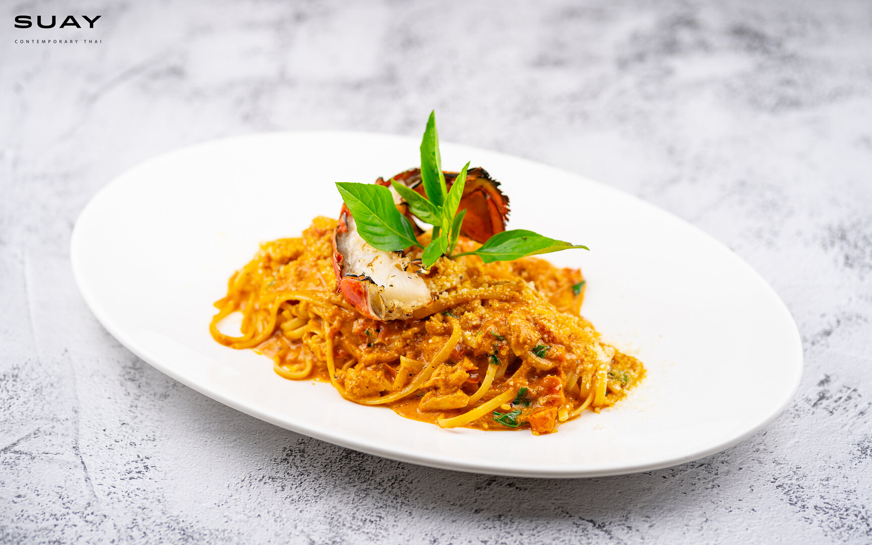 Linguini with lobster bisque and tomato sauce served with crab meat and grilled half lobster tail.