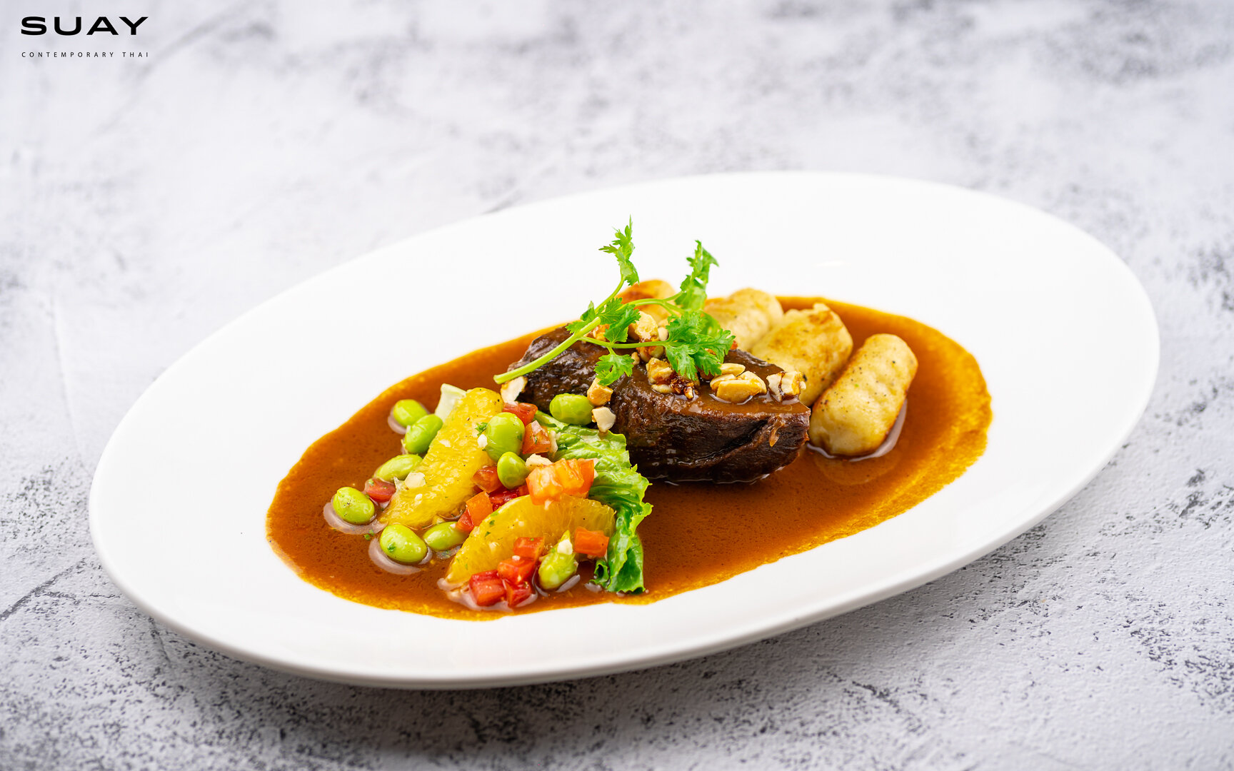 *Signature* braised beef cheek in massaman curry, coconut gnocchi, edamame bean salsa & candice cashew nuts.