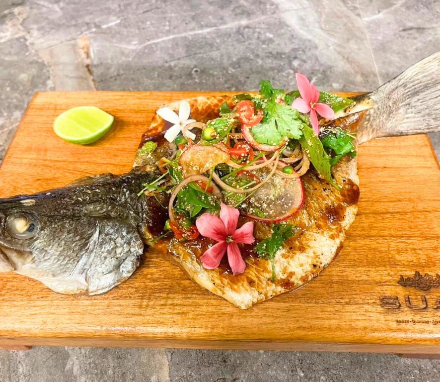 Whole Andaman sea bass with tamarind sauce and sticky rice powder served with spicy thai lsaan salad