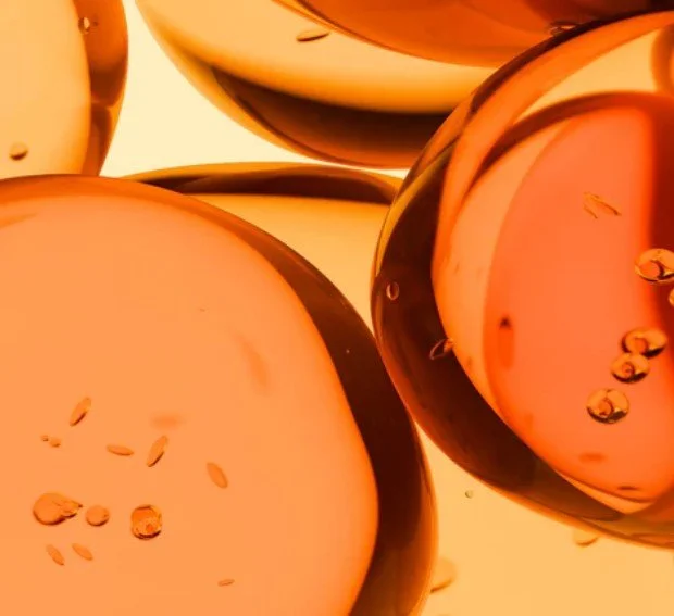 Close-up of several bubbles with orange and black swirling patterns.