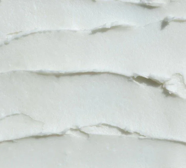 Close-up of white body lotion  with visible creases.