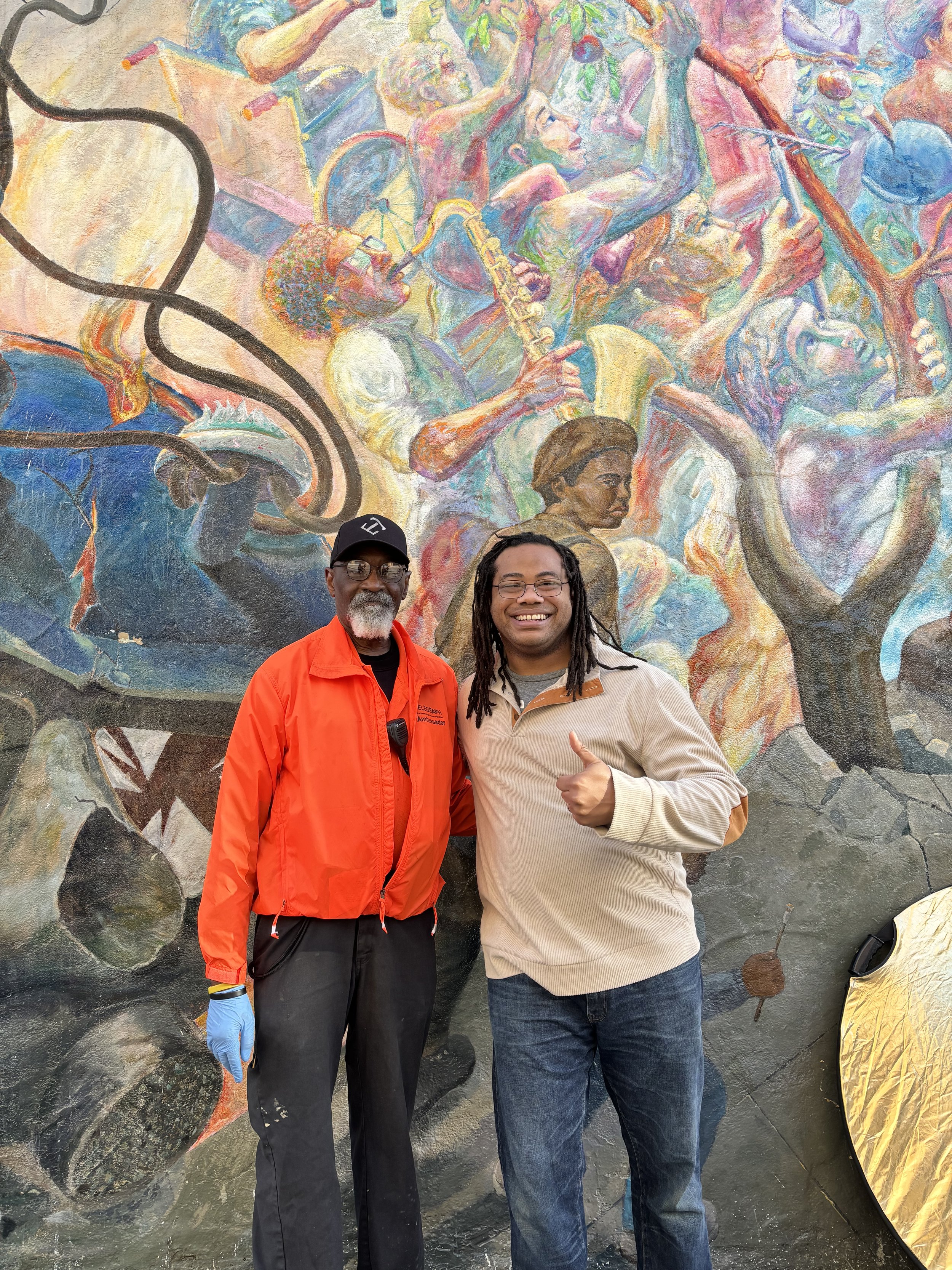 Aidan Hill with a Telegraph BID team member in front of a mural.