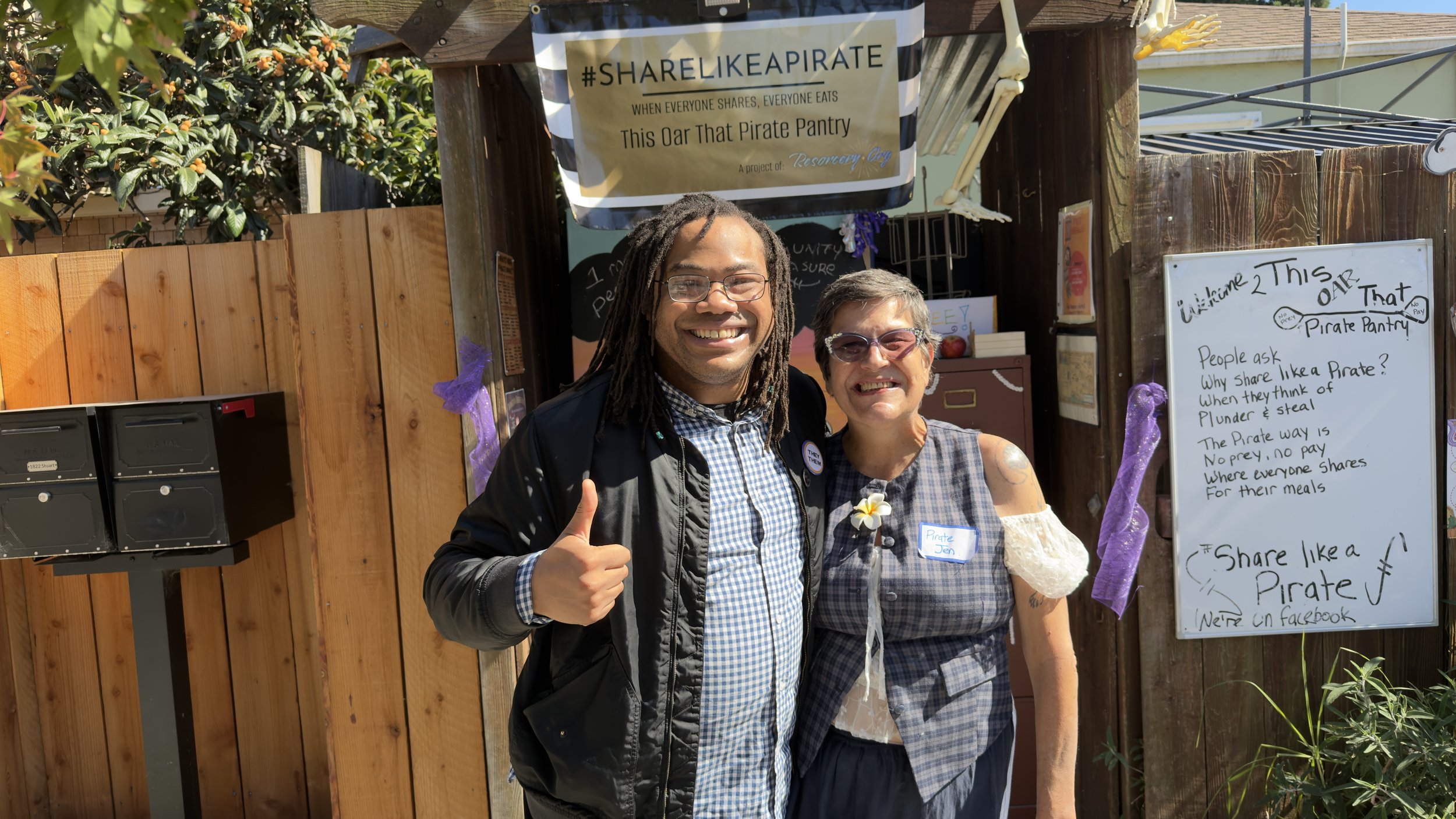 Aidan Hill with a community member at a neighborhood food-sharing project.