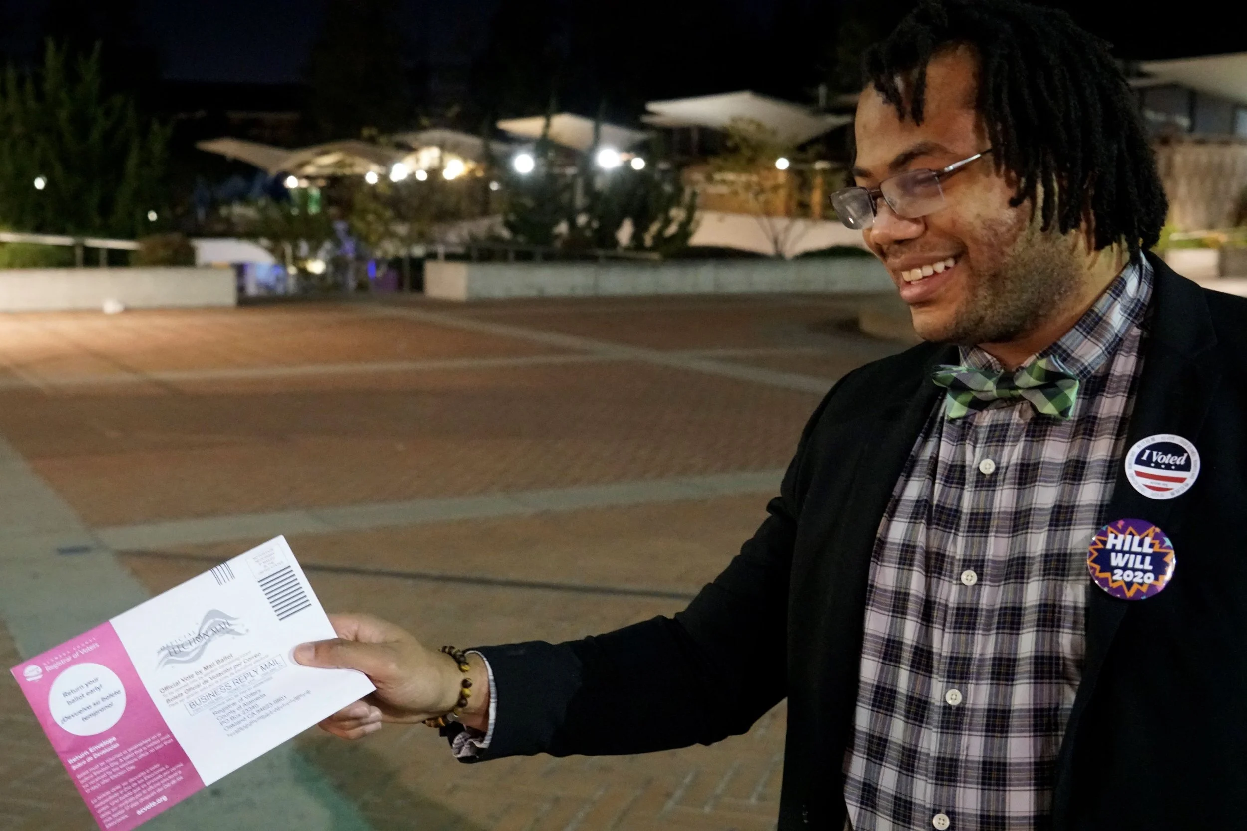Voter holding a ballot and an I Voted sticker.