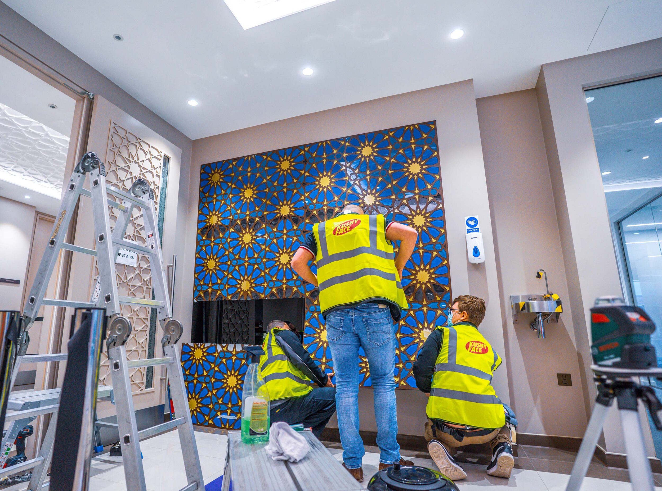 team members installing mosaic piece 
