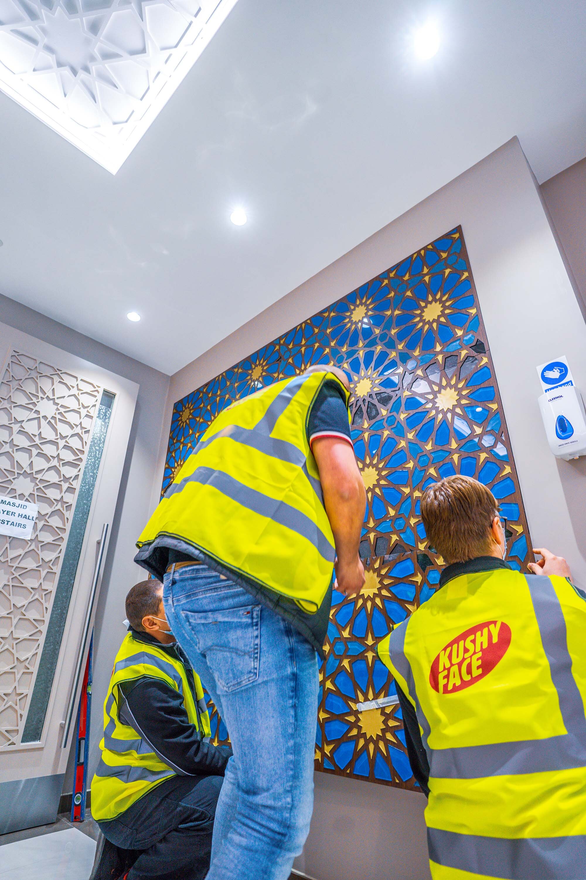team members installing mosaic piece 