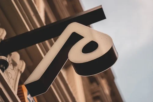 Close-up of a large, stylized number '10' sign mounted on a building exterior.
