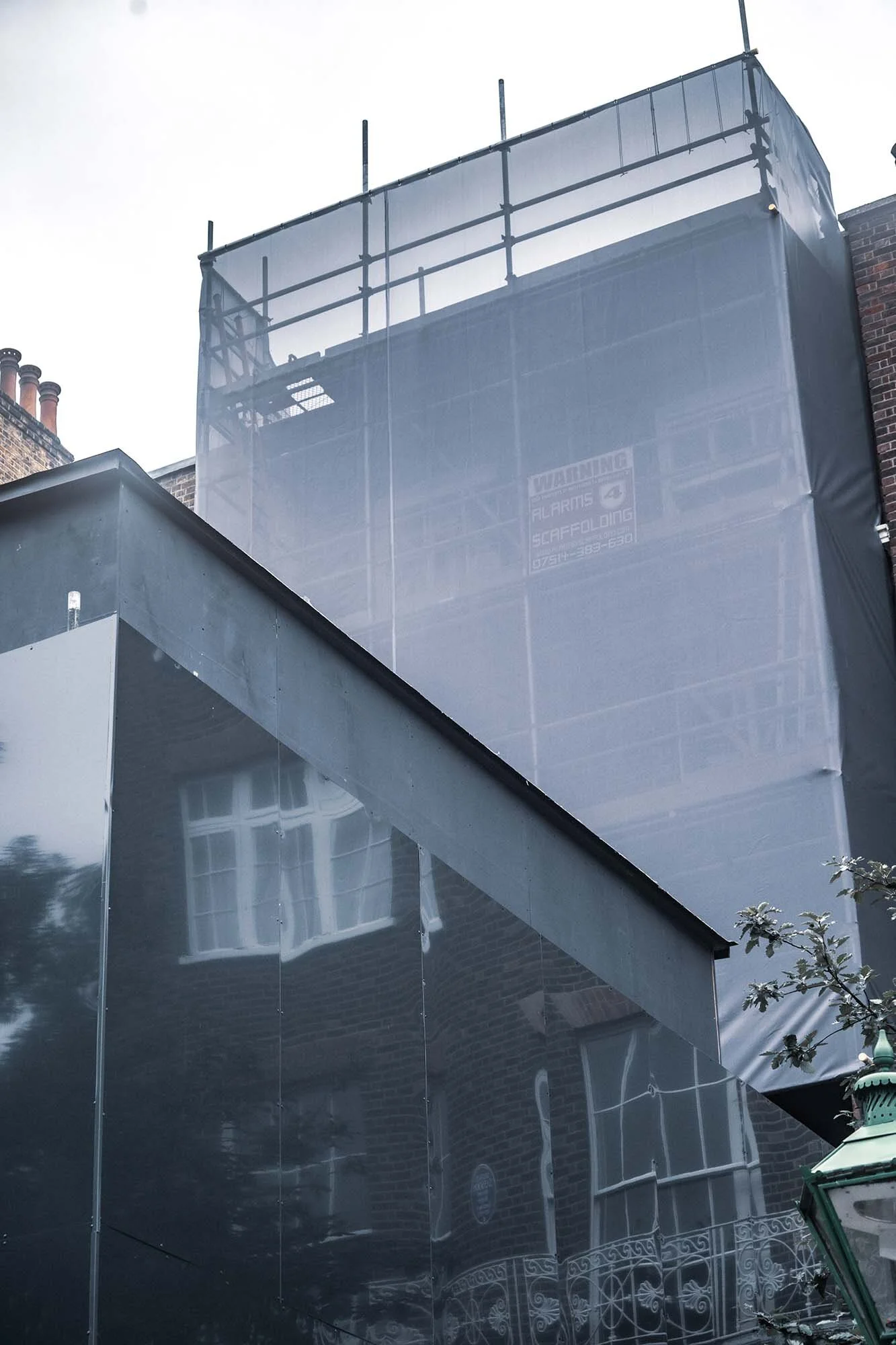 black banner wrap with scaffolding