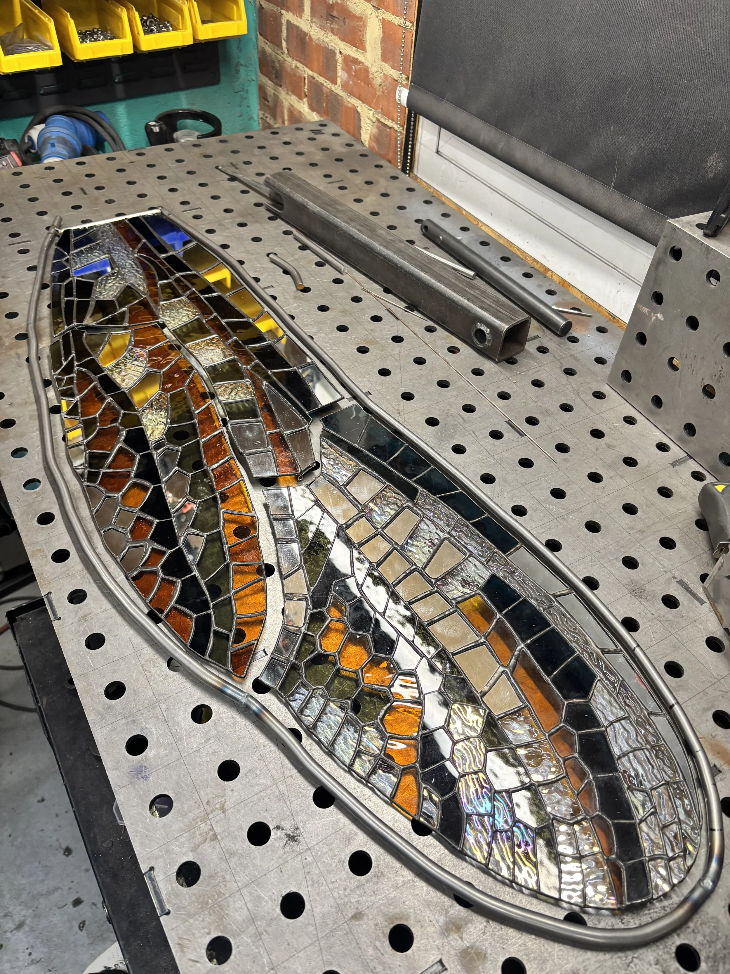 Glass By Butler's Growth stained glass artwork in progress, with individual glass pieces assembled on the workbench.