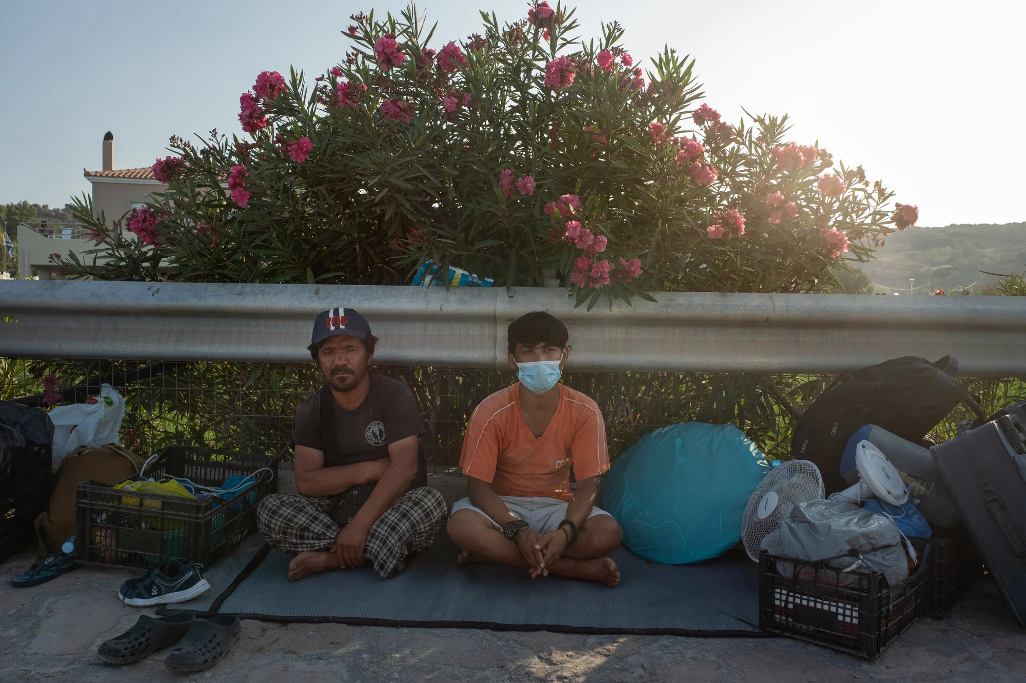  Mavrovouni Camp, Lesbos - 18/09/2020  Mr. Akhlaghi on the side of the road, waiting to enter the new camp for the first time. Weeks after the fire, Mr. Akhlaghi still makes the 30-minute journey by foot to Moria several times a week to feed the home