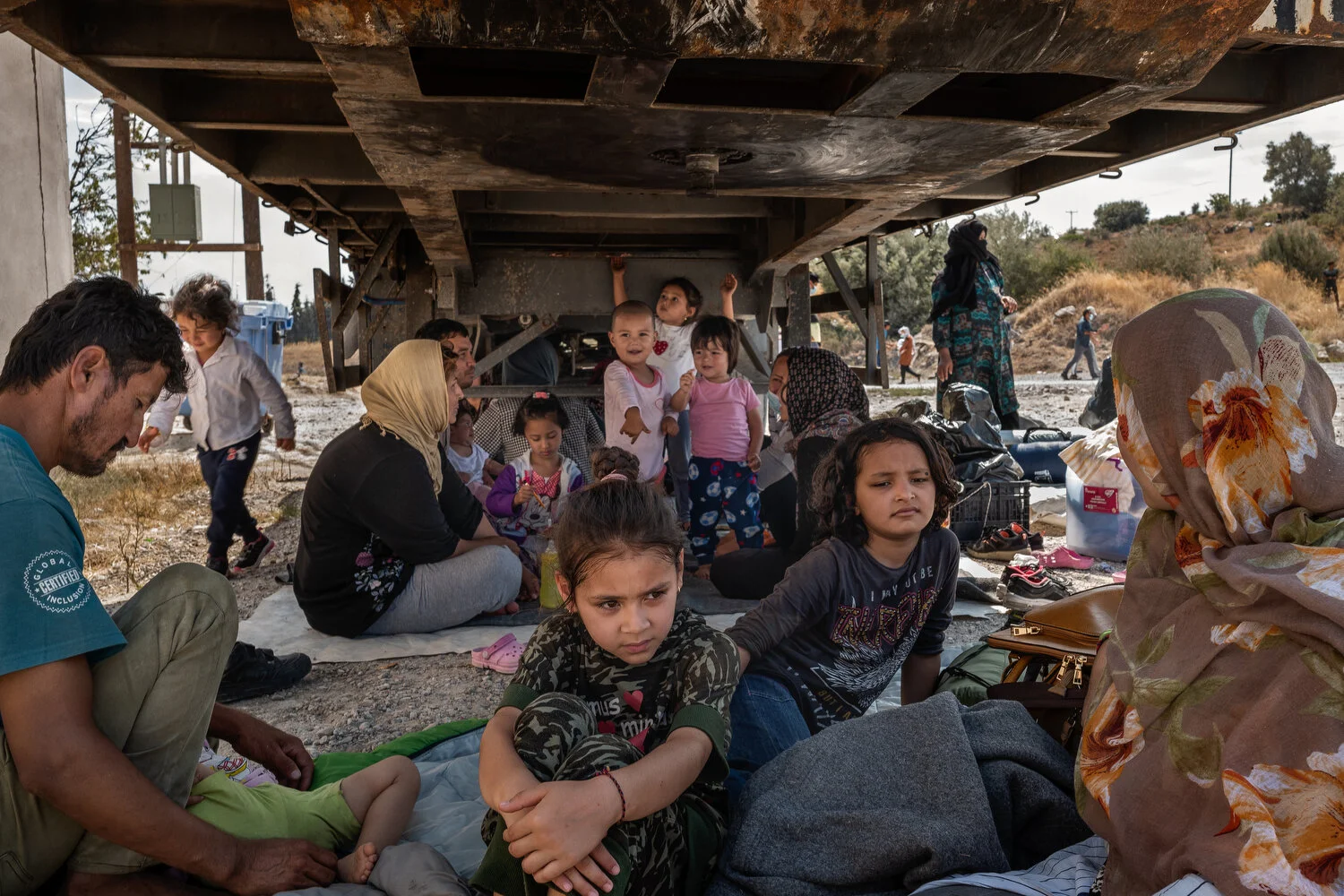  Kara Tepe, Lesbos - 12/09/2020  Afghan migrant families seek shelter from the sun under a trailer after a fire destroyed the migrant camp Moria where they were living. After the fire, most asylum seekers fled to the surrounding streets. As the migra