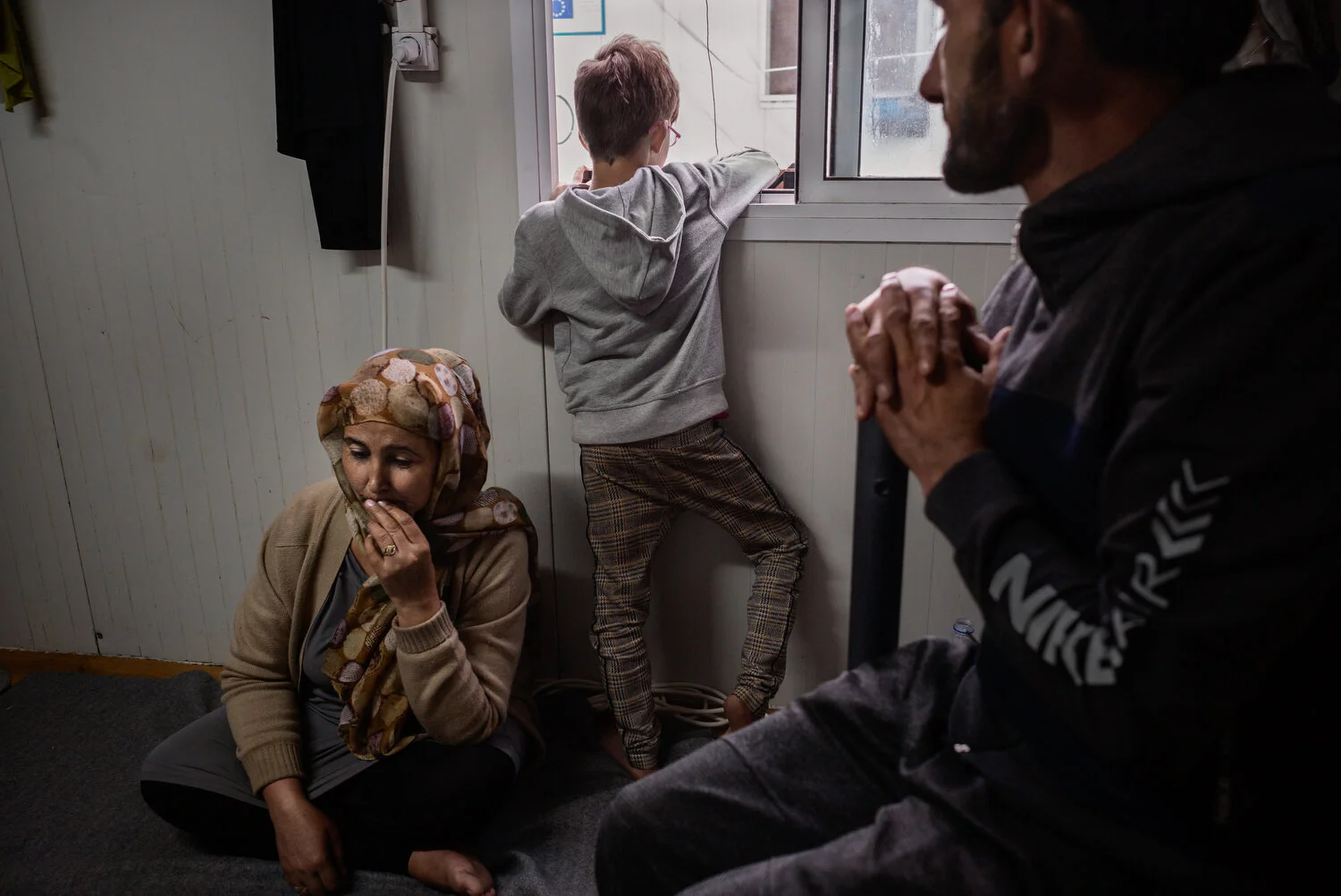  Moria Camp, Lesbos - 22/11/2019  Annaita, Mariam, and Mohammed Alim Akburu from Afghanistan, in the official Moria camp. Their family of eight shares the container with another large family. They have been on Lesbos for nine months, and are waiting 