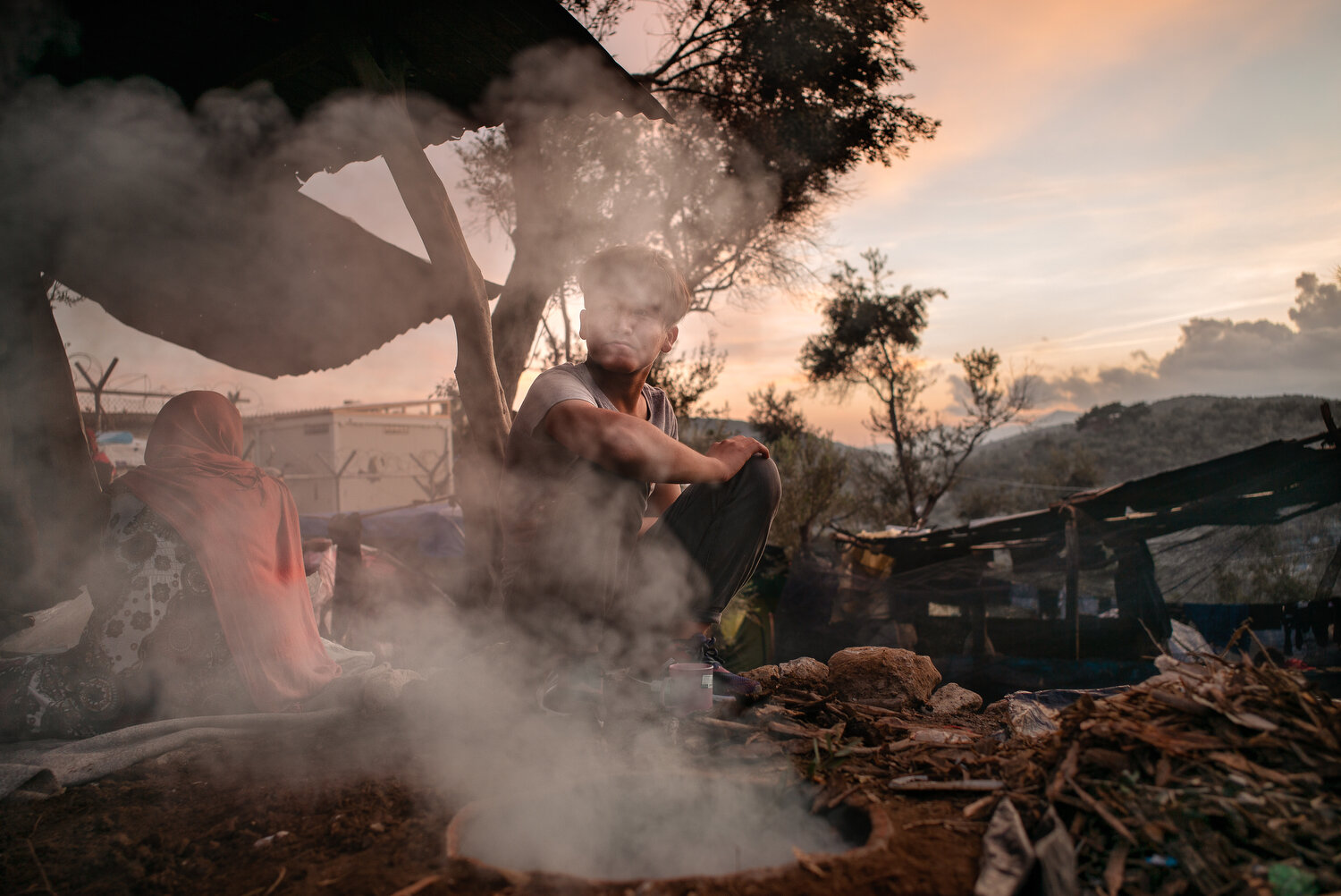  Moria Camp, Lesbos - 23/11/2019  A young Afghan migrant looks out over the Moria Camp by a makeshift bakery.  