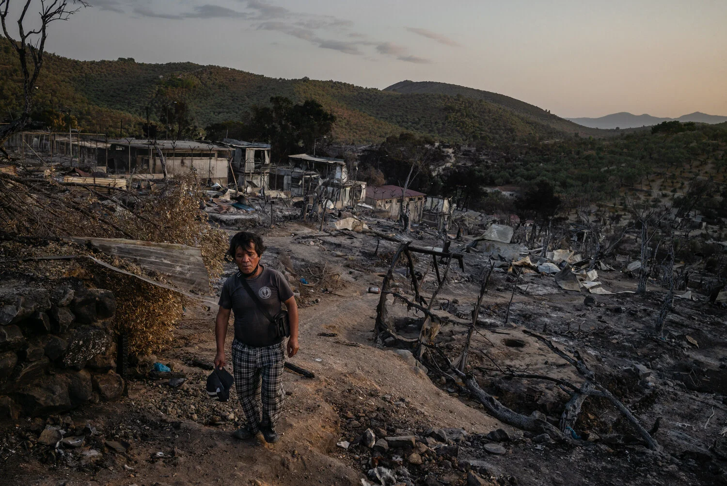  Moria Camp, Lesbos - 26/09/2020  Abdul Ali Akhlaghi (age 55) from Ghazni, Afghanistan walks through the ruins of the Moria camp. When it burned down in a large fire, it left nearly 13,000 migrants homeless, again. Akhlaghi's family is still in Iran,