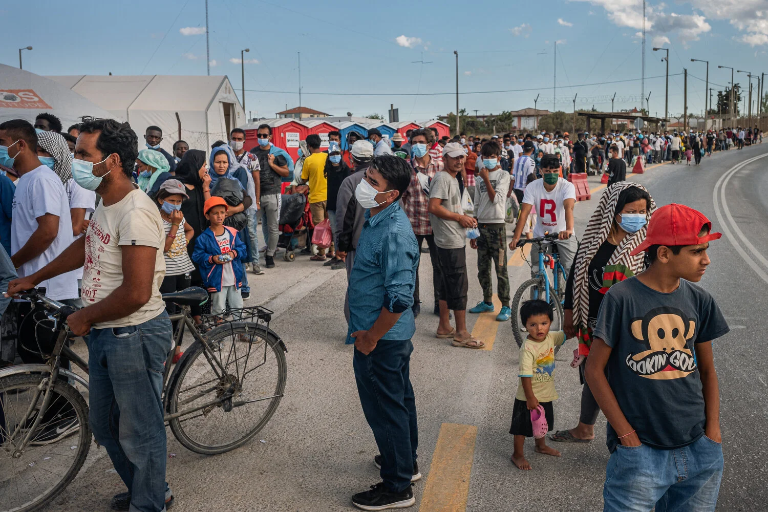  Mavrovouni Camp - 01/10/2020  The line in front of the new camp that forms daily due to heavy security checks by Greek authorities. The asylum seekers in the camp are only allowed outside for limited periods of time. On Sundays and holidays, the cam