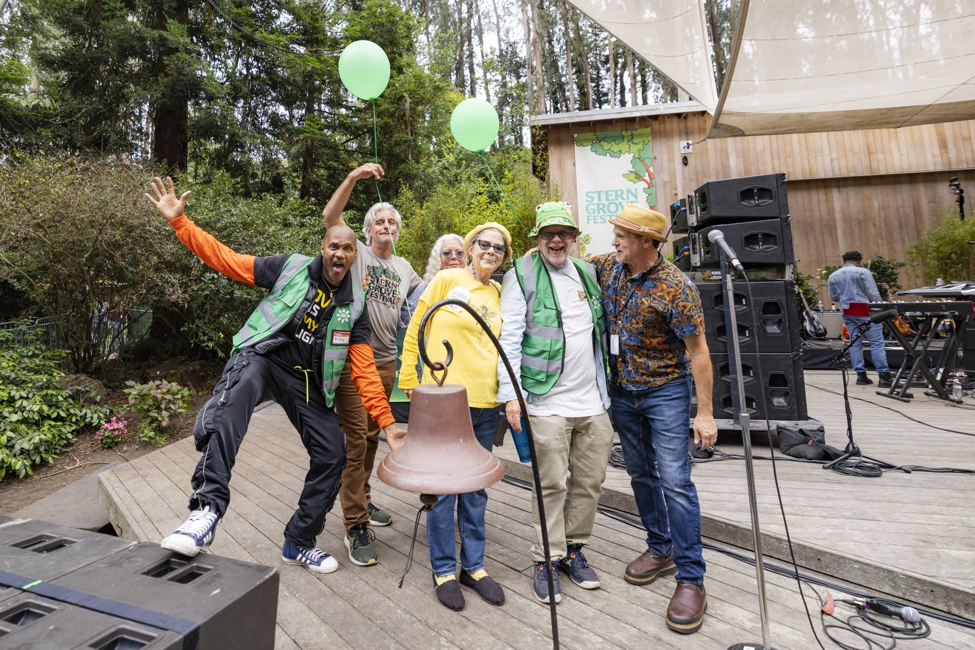 woman volunteer for stern grove, holding a balloon and smiling