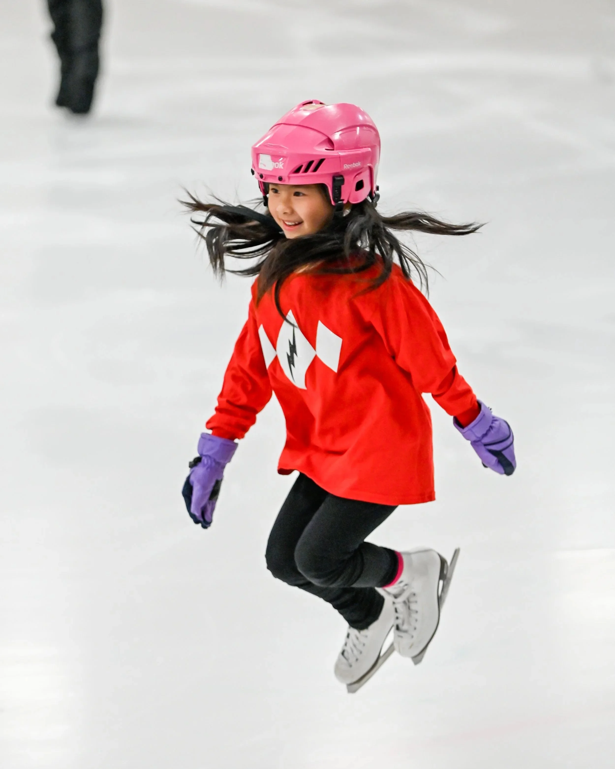 Young figure skater jumping in the air