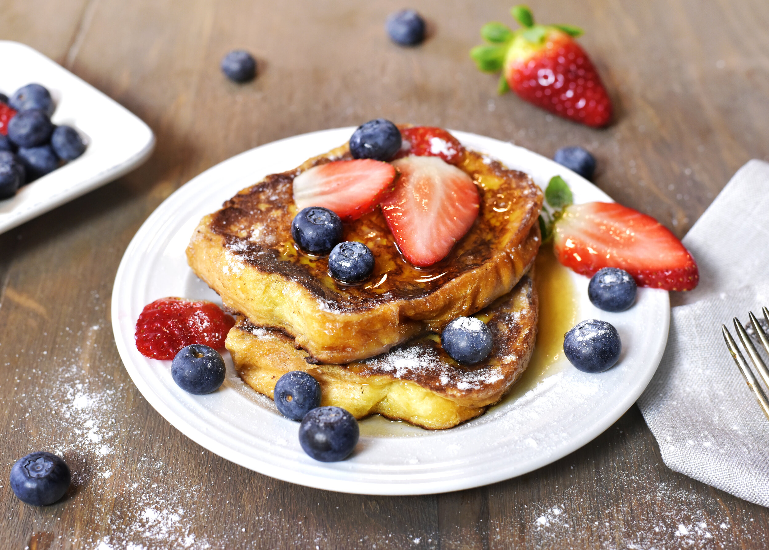 Challah French toast with warm maple syrup and fresh fruit
