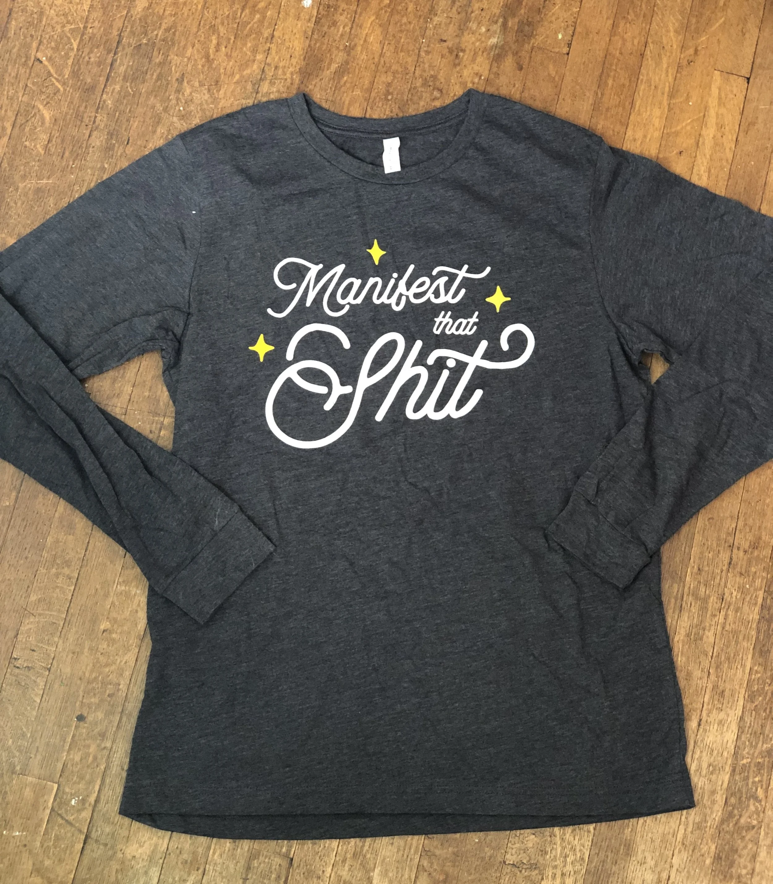 "MANIFEST THAT SHIT" Bella Canva Long Sleeve T-shirt in Charcoal Grey