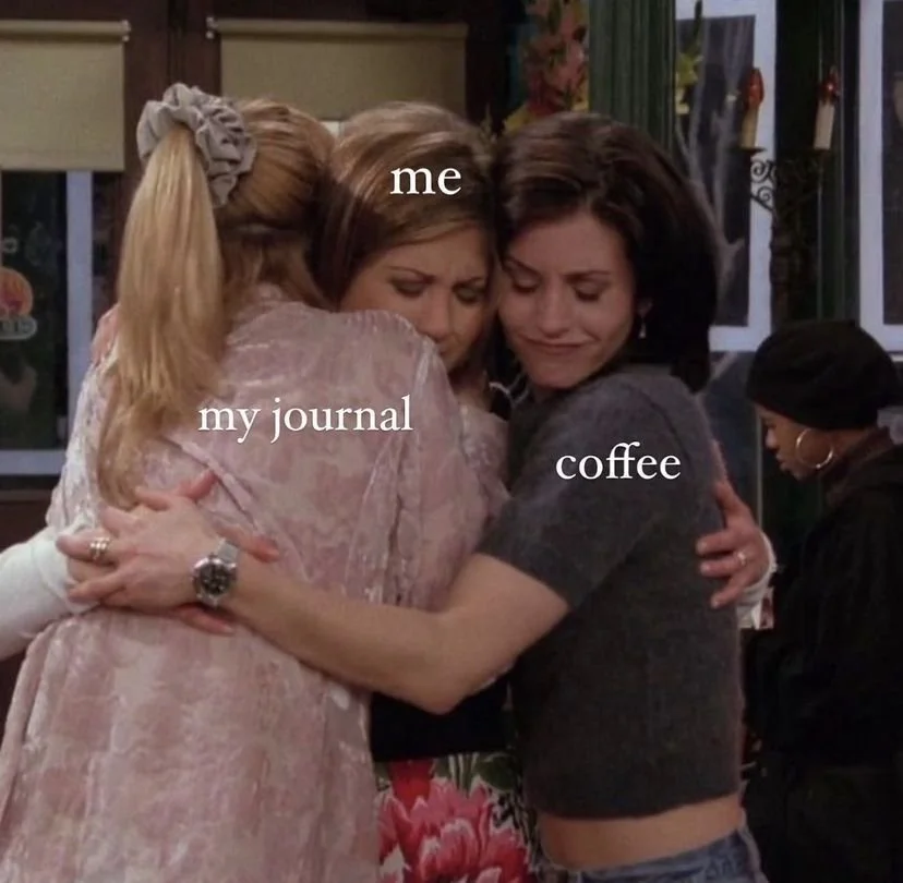 Three women hugging in a cozy setting, with one woman labeled 'me,' another labeled 'my journal,' and the third labeled 'coffee.'