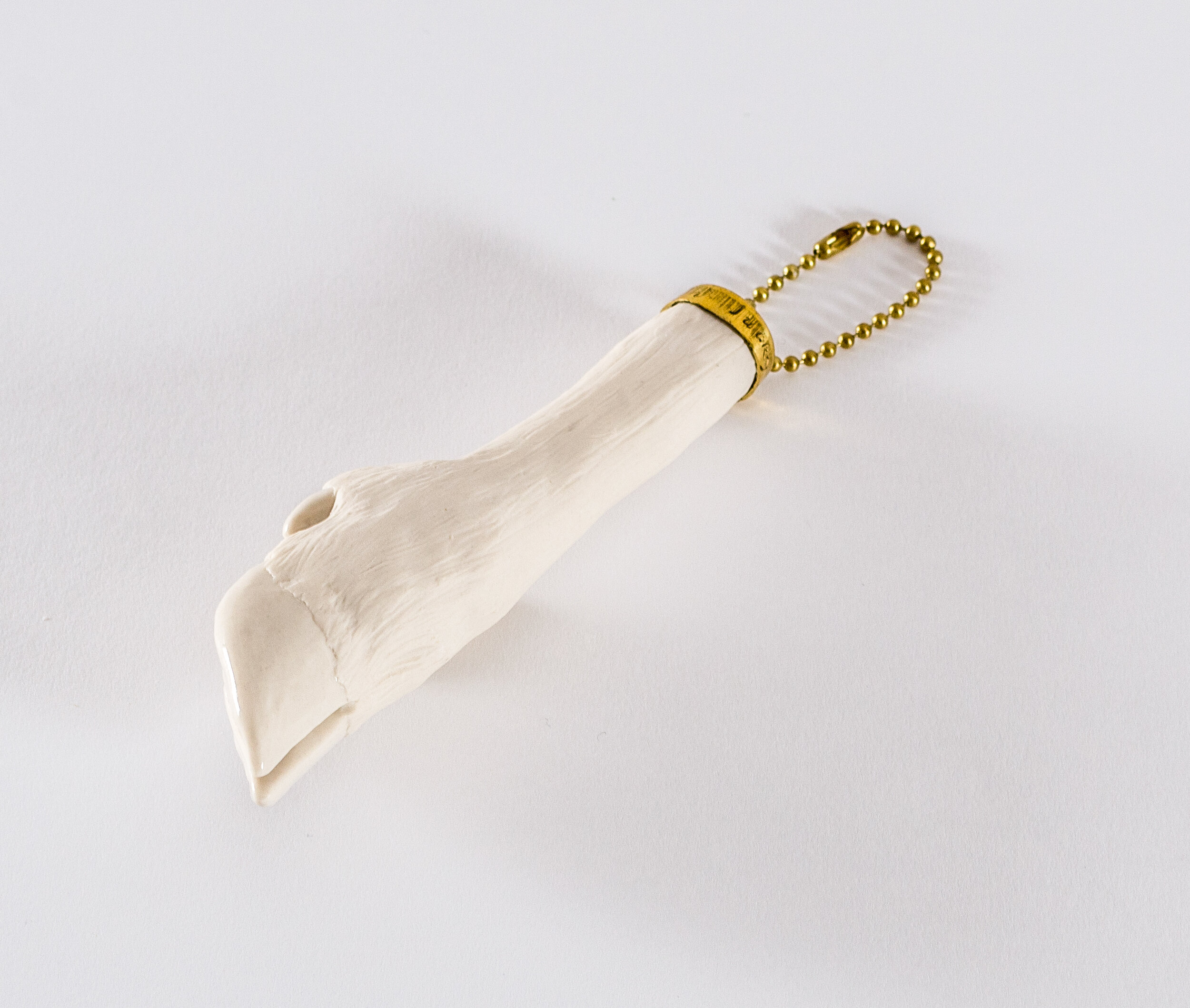 lucky charm, porcelain, glaze, brass, brass ball chain, 8” x 1.75” x 1.75”