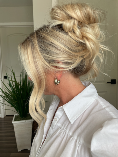 Modern voluminous high bridal bun with an effortless, 'undone' texture for a chic, contemporary wedding style in Raleigh, NC.