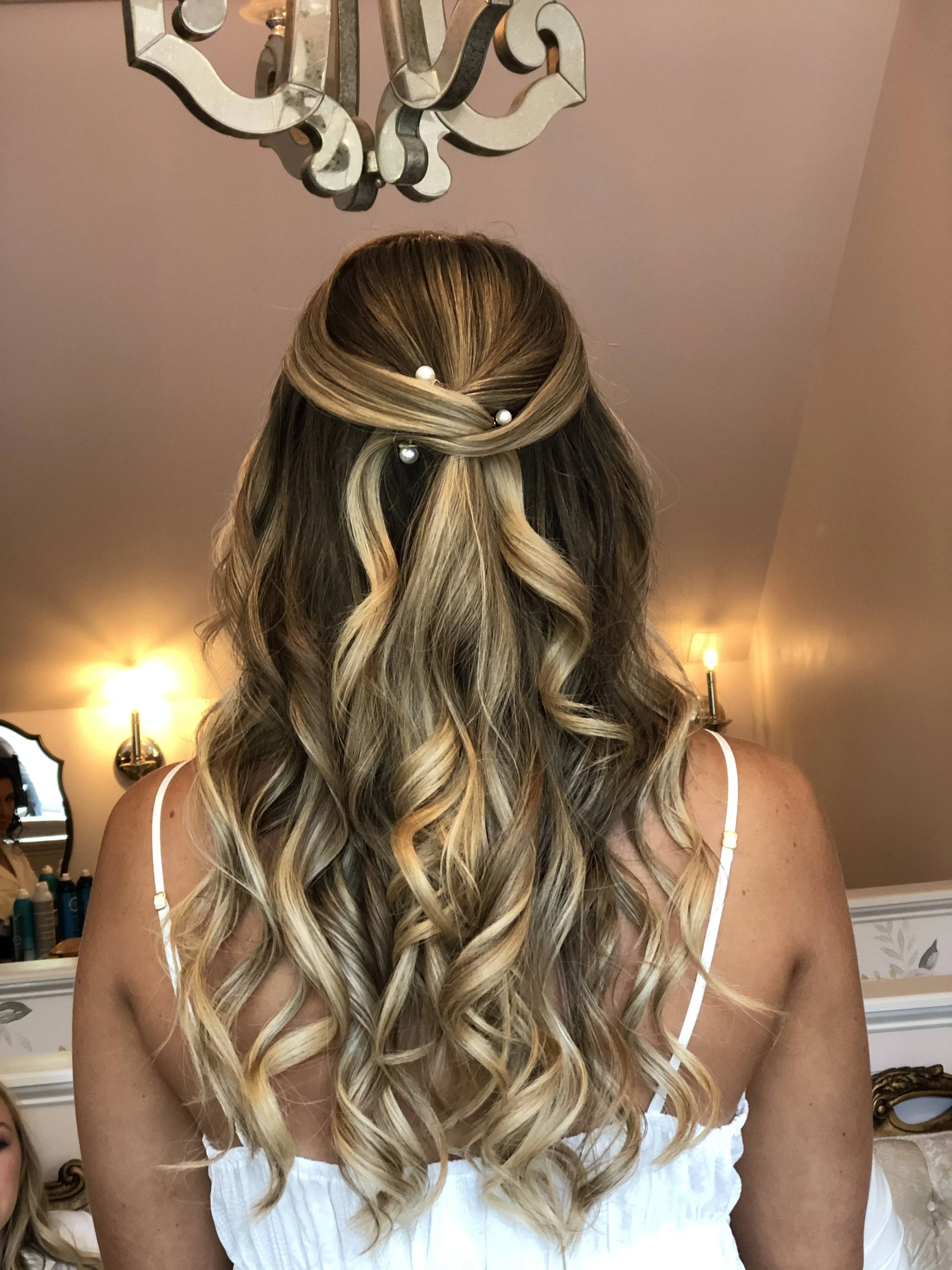 Polished half-back bridal hairstyle with high-gloss curls for a luxury wedding at a Raleigh, North Carolina estate venue.