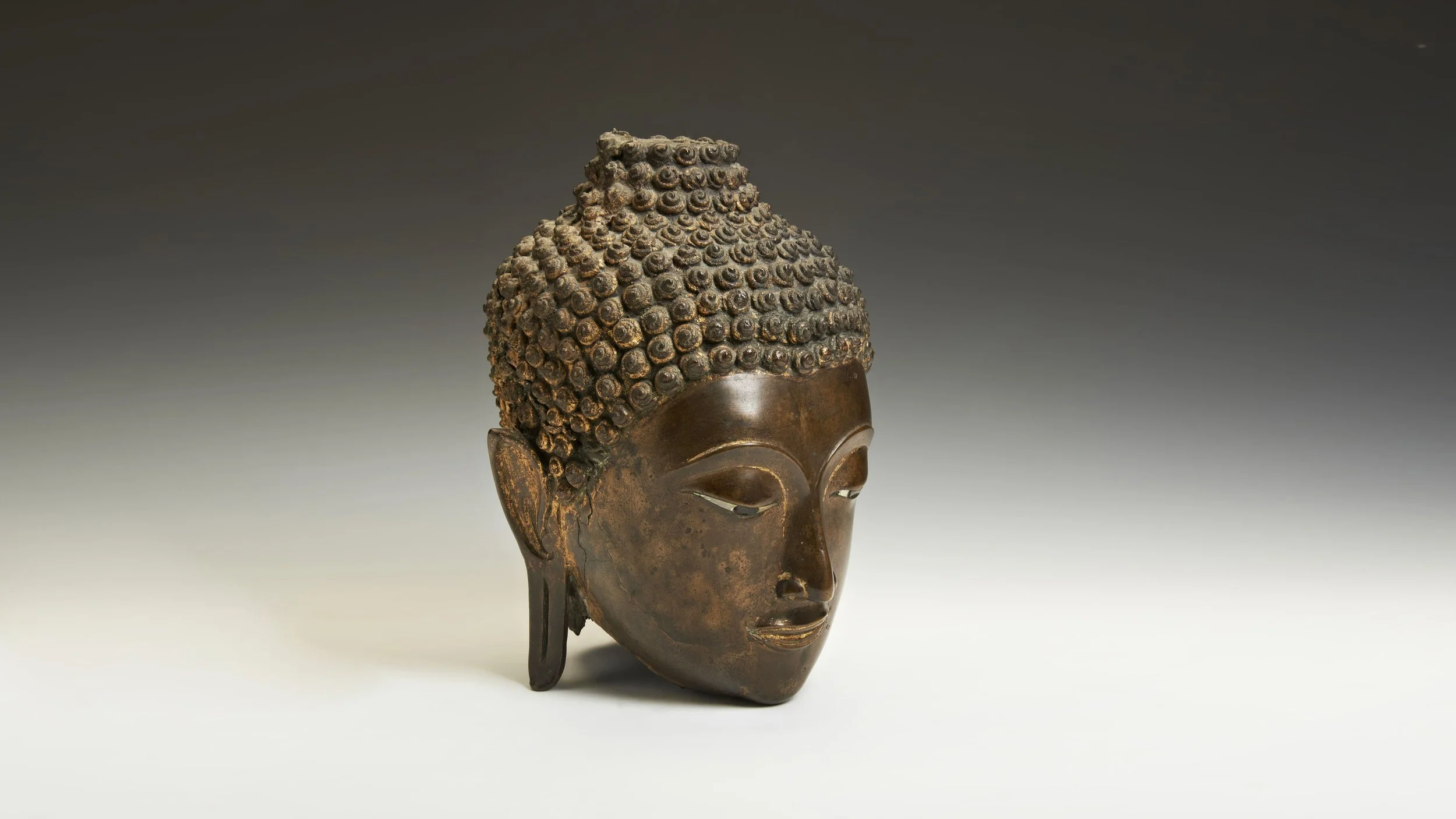 MONDAY 10 NOVEMBER AT 9:30AM
FINE ASIAN ART
RARE BRONZE BUDDHA HEAD, THAILAND, 16TH CENTURY
PROVENANCE: From the collection of Alan and Joan Scott, acquired in Hong Kong in 1971
ESTIMATE: £15,000 - £25,000