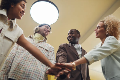 People putting hands in a circle