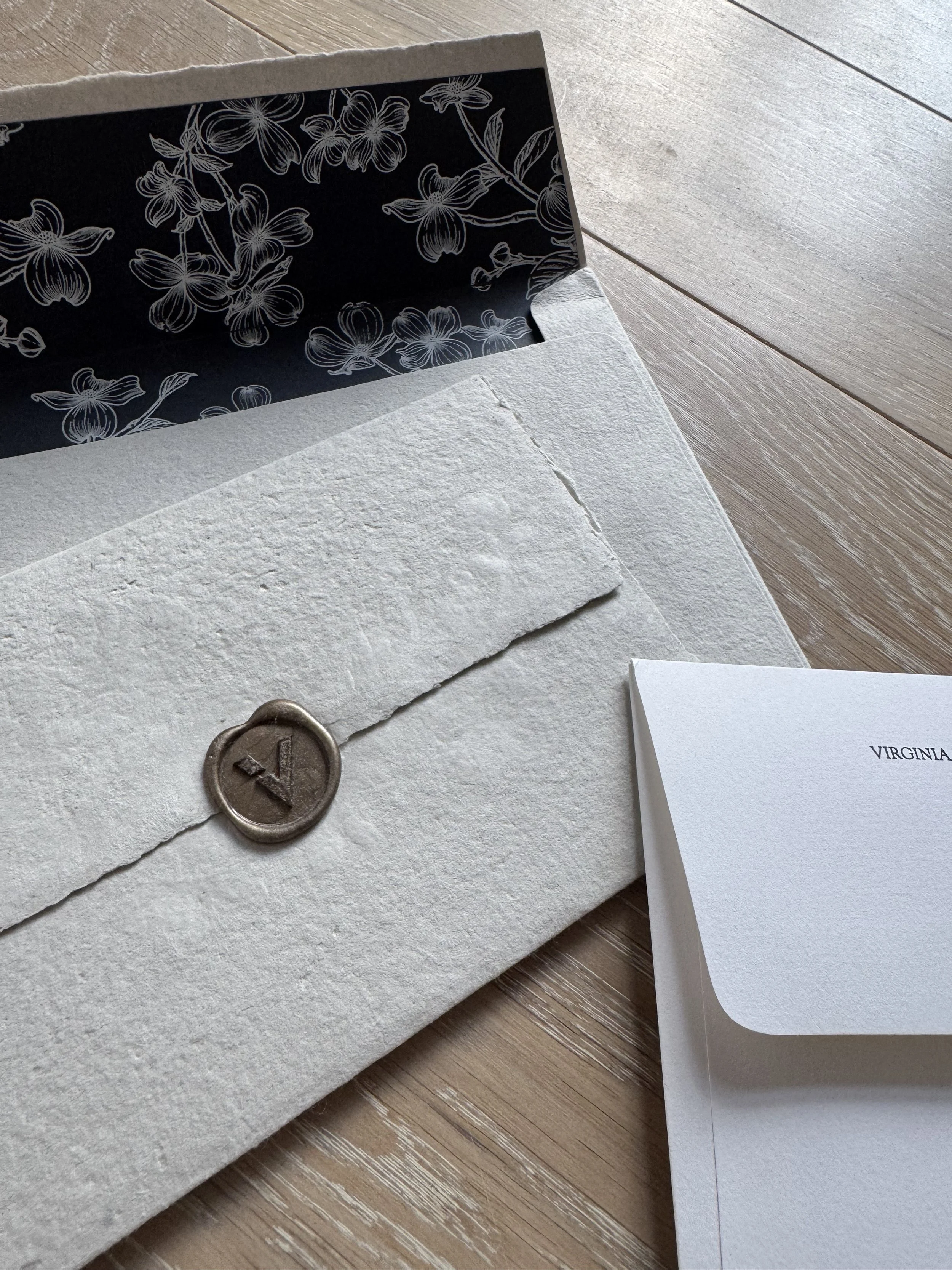 Invitation packaging: handmade paper, V wax seal, custom dogwood illustration
