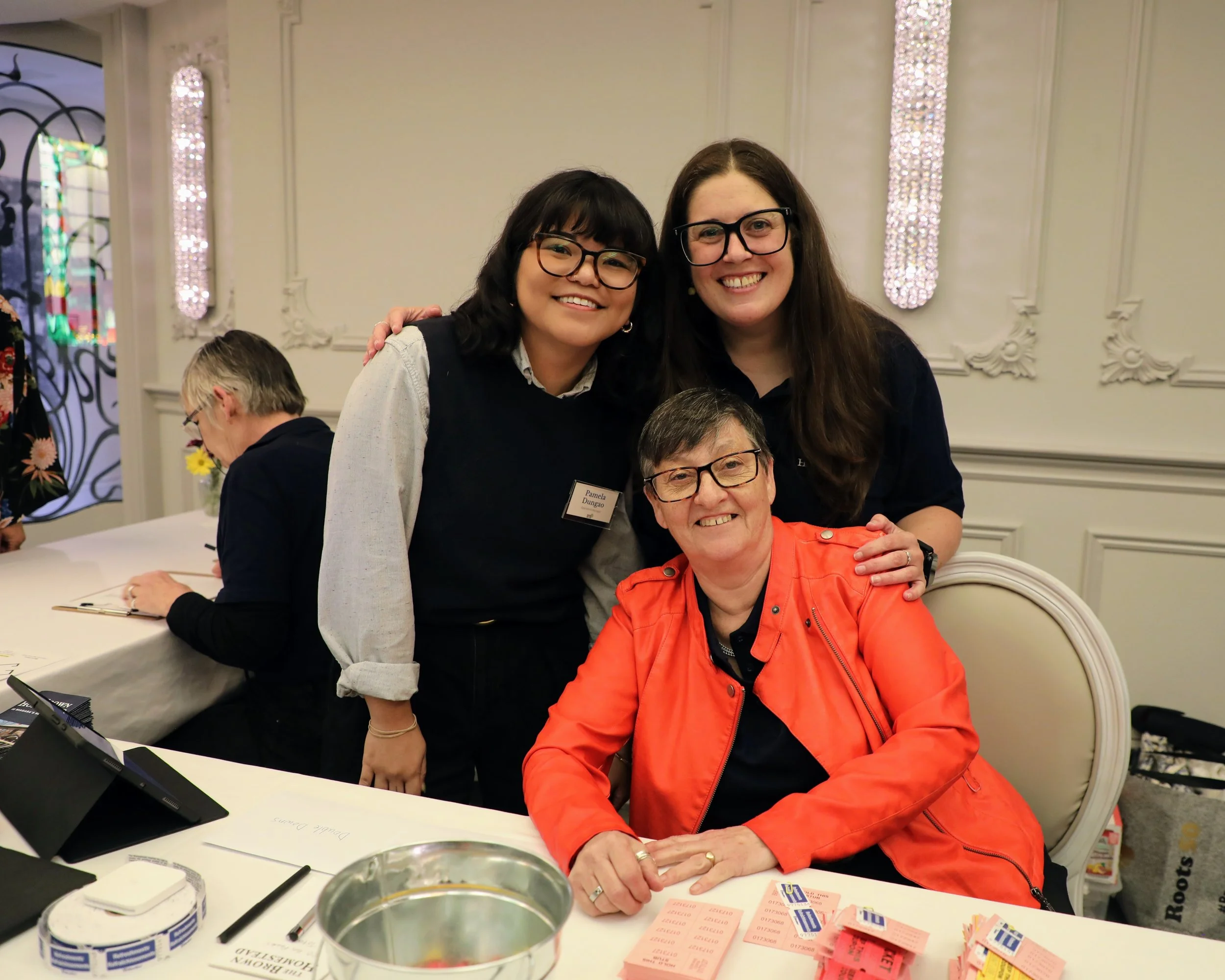 trivia night staff volunteer smiles 2025.JPG