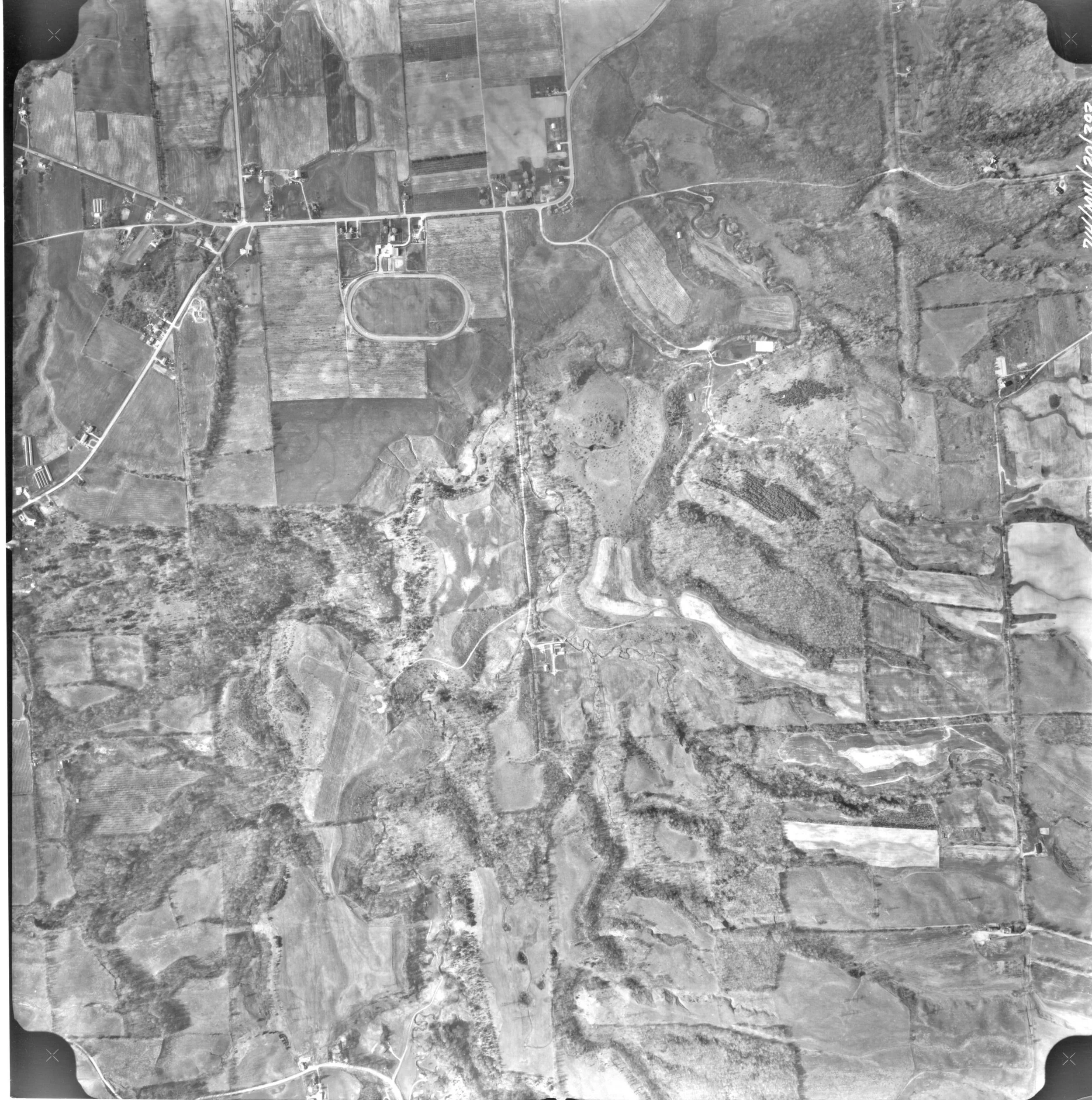 An aerial photo taken of the Short Hills in 1971. Farmland is seen on the hill tops, surrounded by weaving wooded-areas. A few roads wind through.
