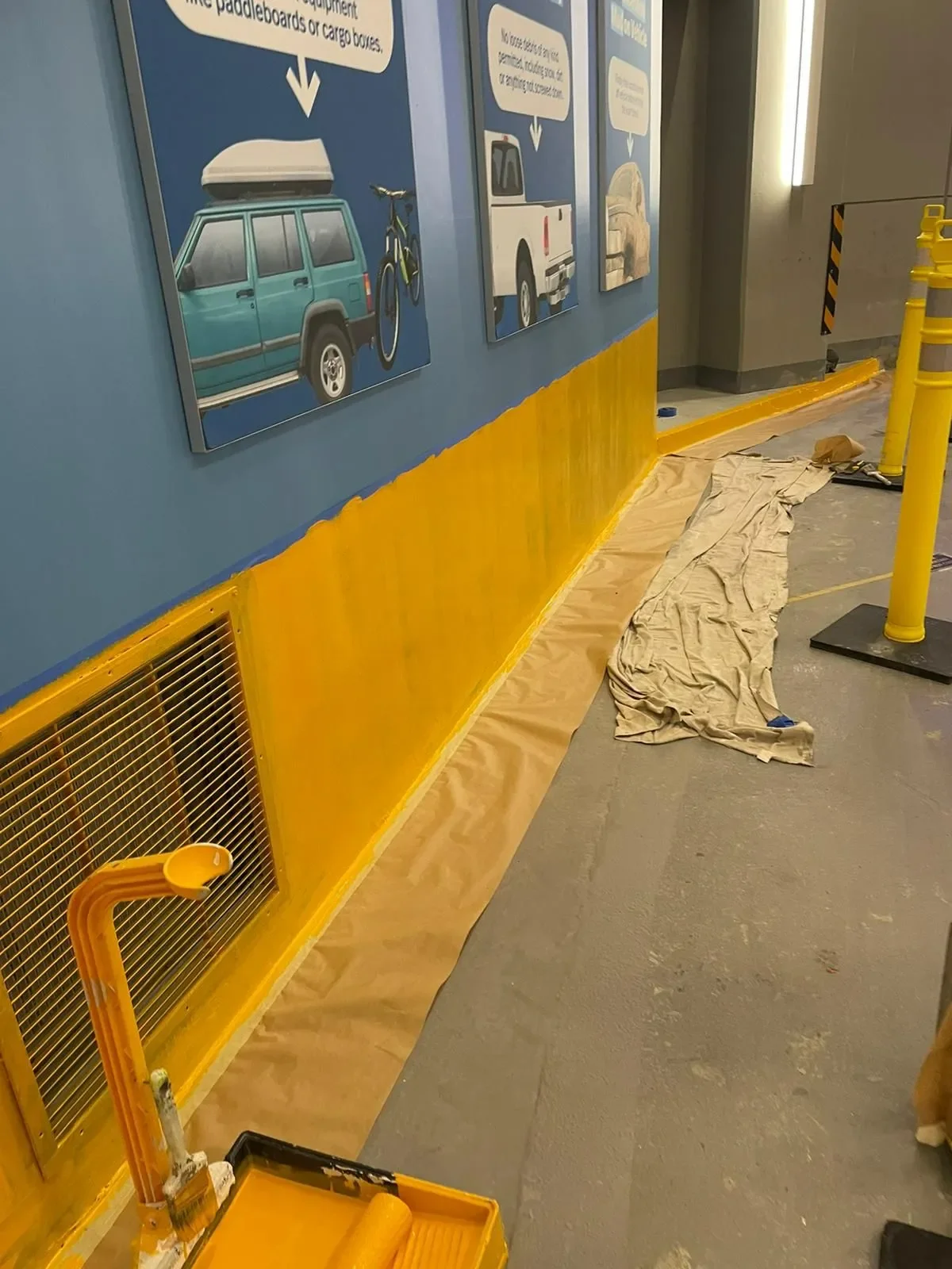 Hallway under renovation with blue walls and yellow trim, painted by professional painters offering free painting estimate and interior painting services near you.