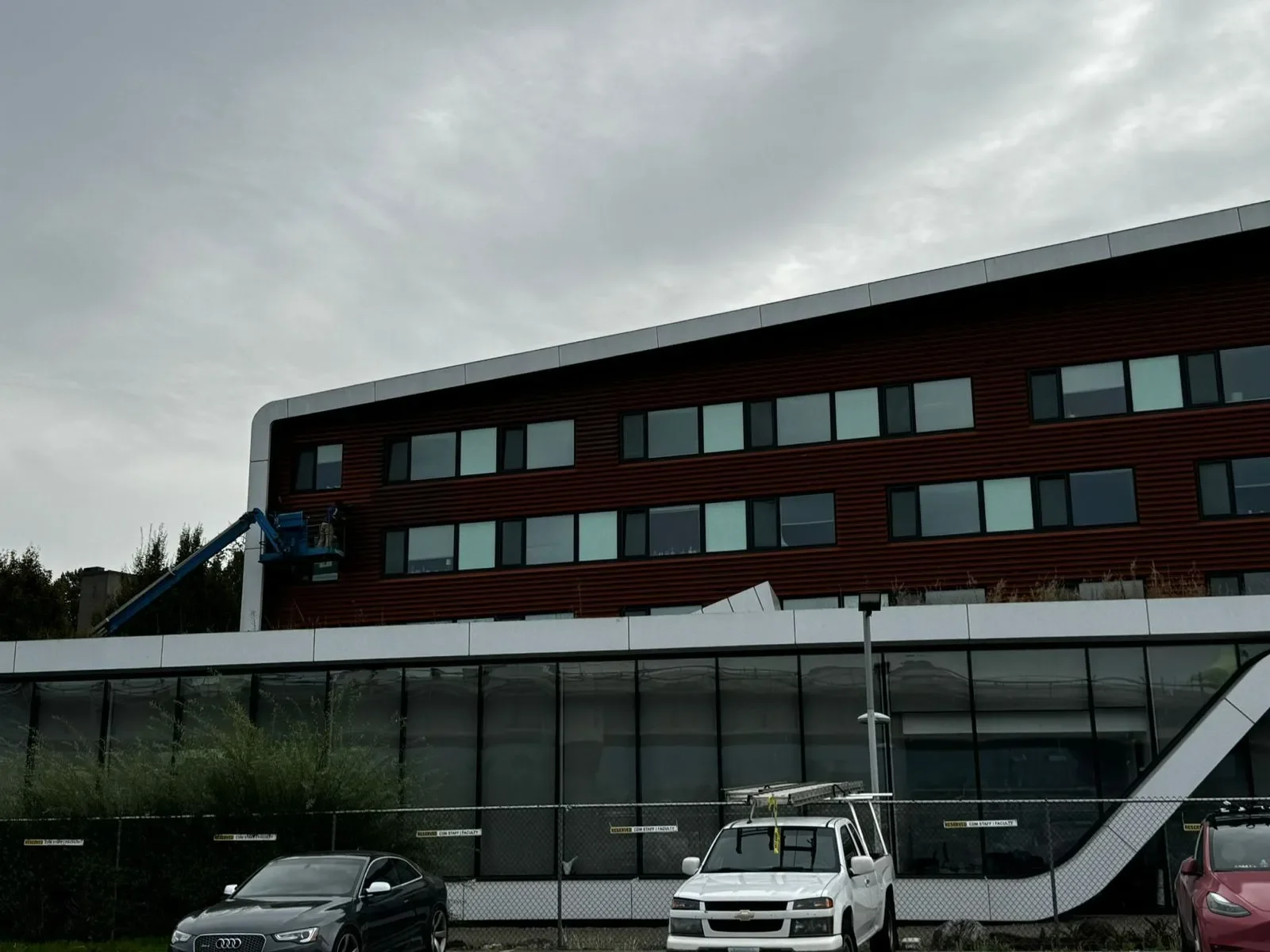 Professional painters working on a multi-story commercial building exterior, providing painting quote, free painting estimate, and exterior painting services near you.