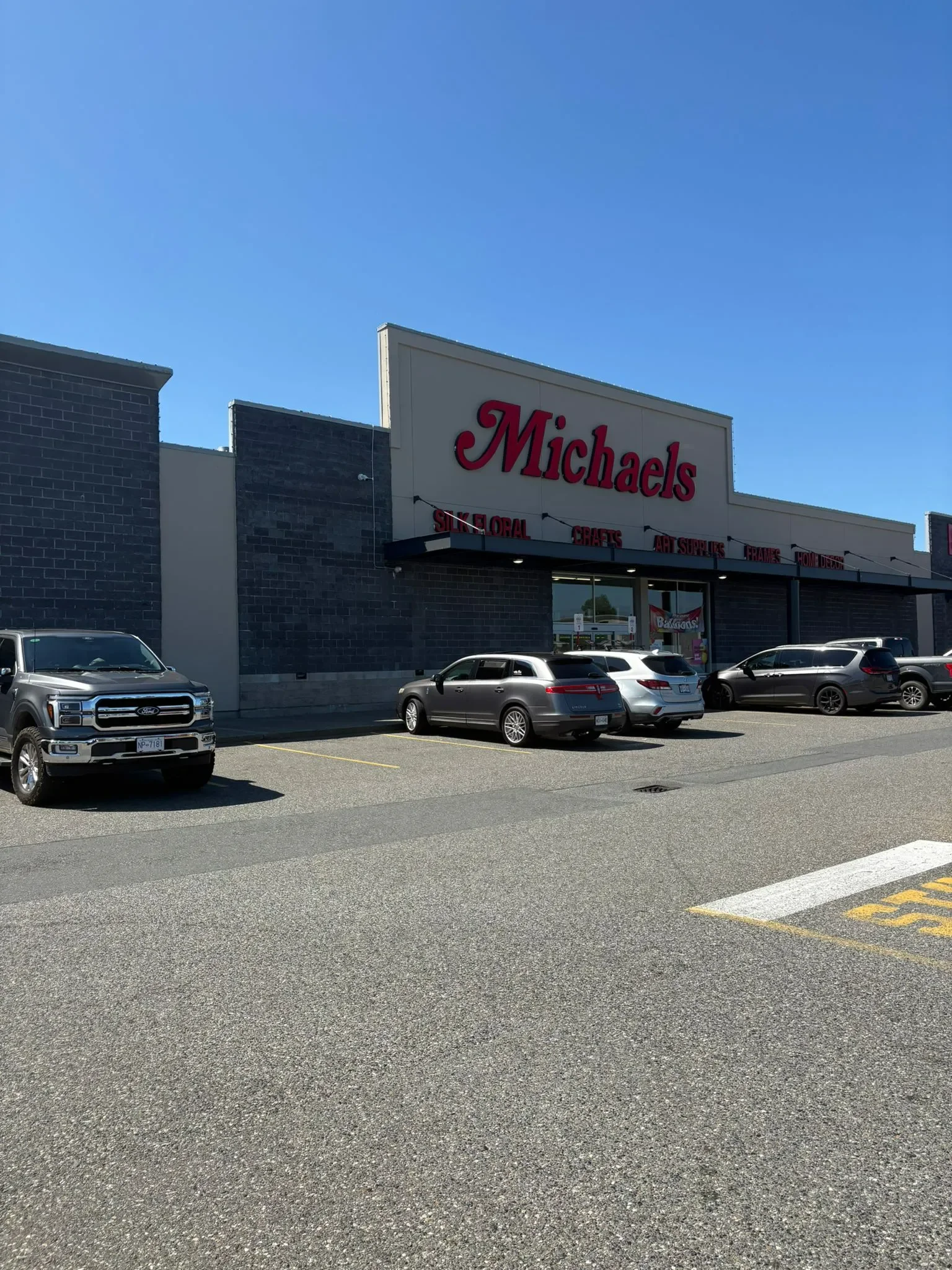 Professional painters working on the exterior of Michaels arts and crafts store, offering free painting estimate and exterior painting services near you.