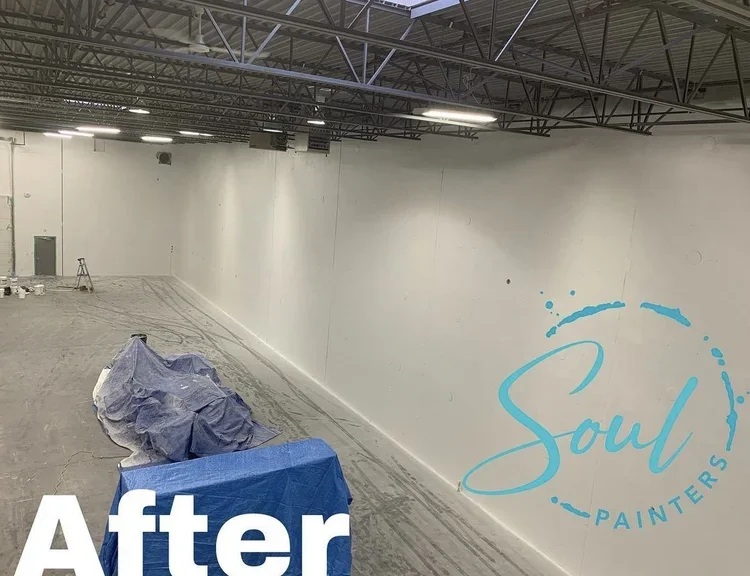 Interior of large room under renovation with high ceiling, covered object, table in foreground, and "after" with "Soul Painters" logo overlaid, painted and maintained by painters offering free interior painting estimate near you.