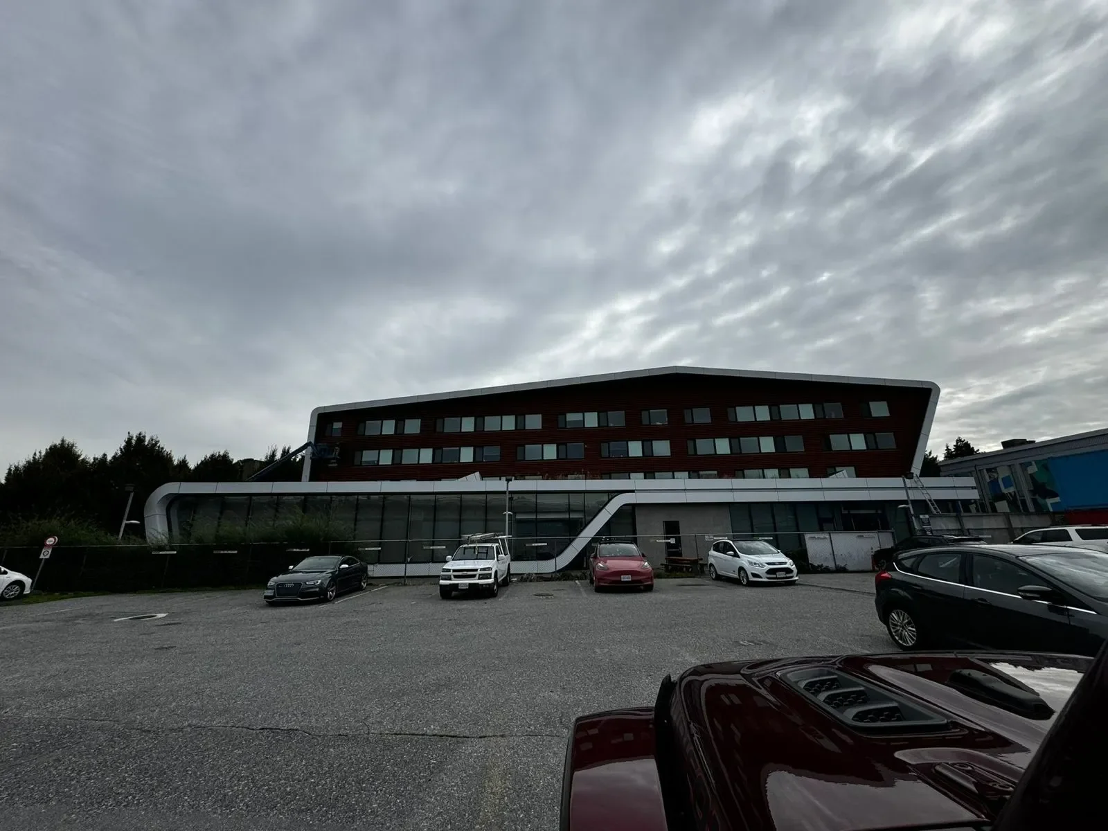 Modern commercial building exterior with parking lot, showcasing professional exterior painting services and free painting estimate by local painters near you.