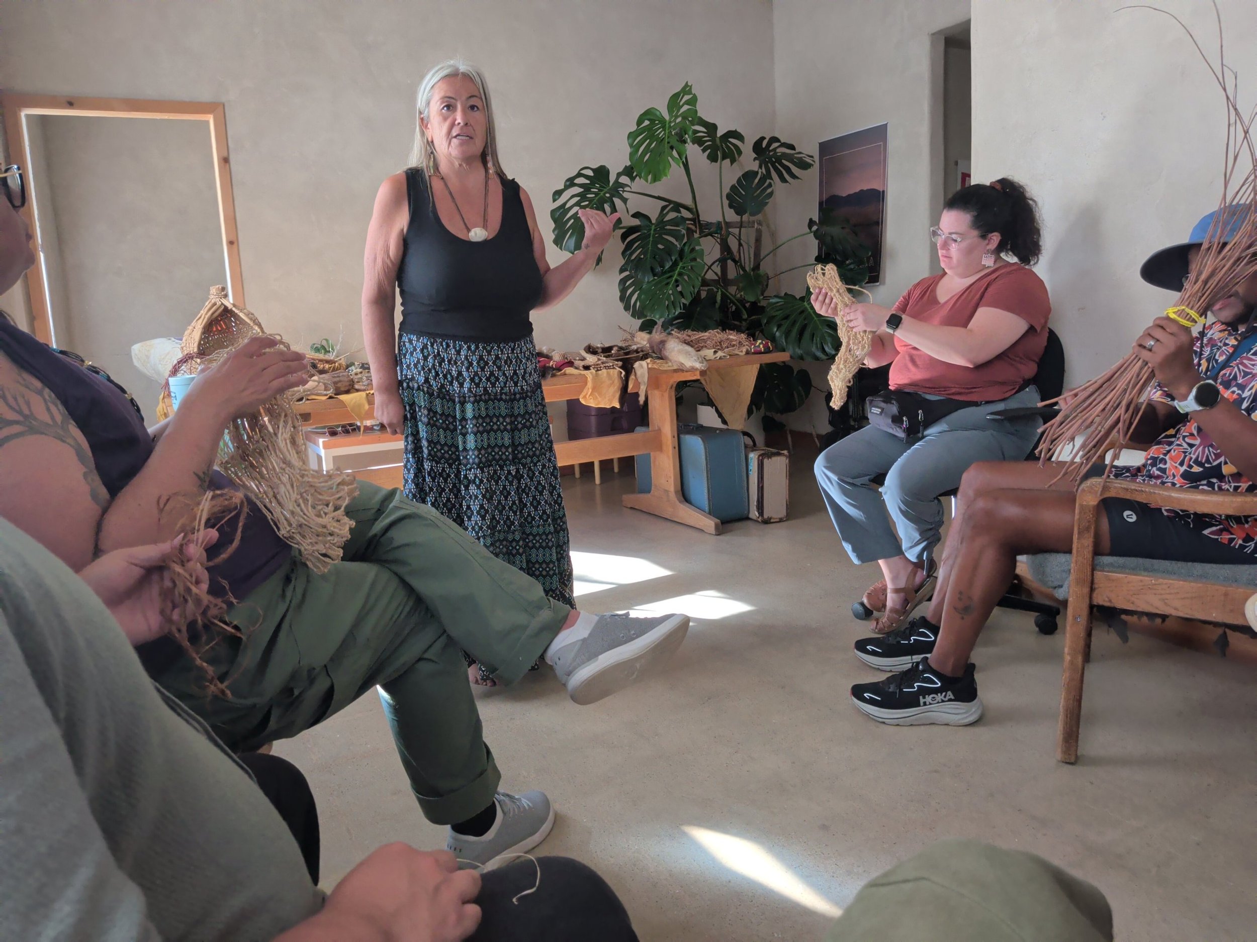 A guest teacher leads a fiber-weaving circle with Kindred members at the 2026 Kindred retreat